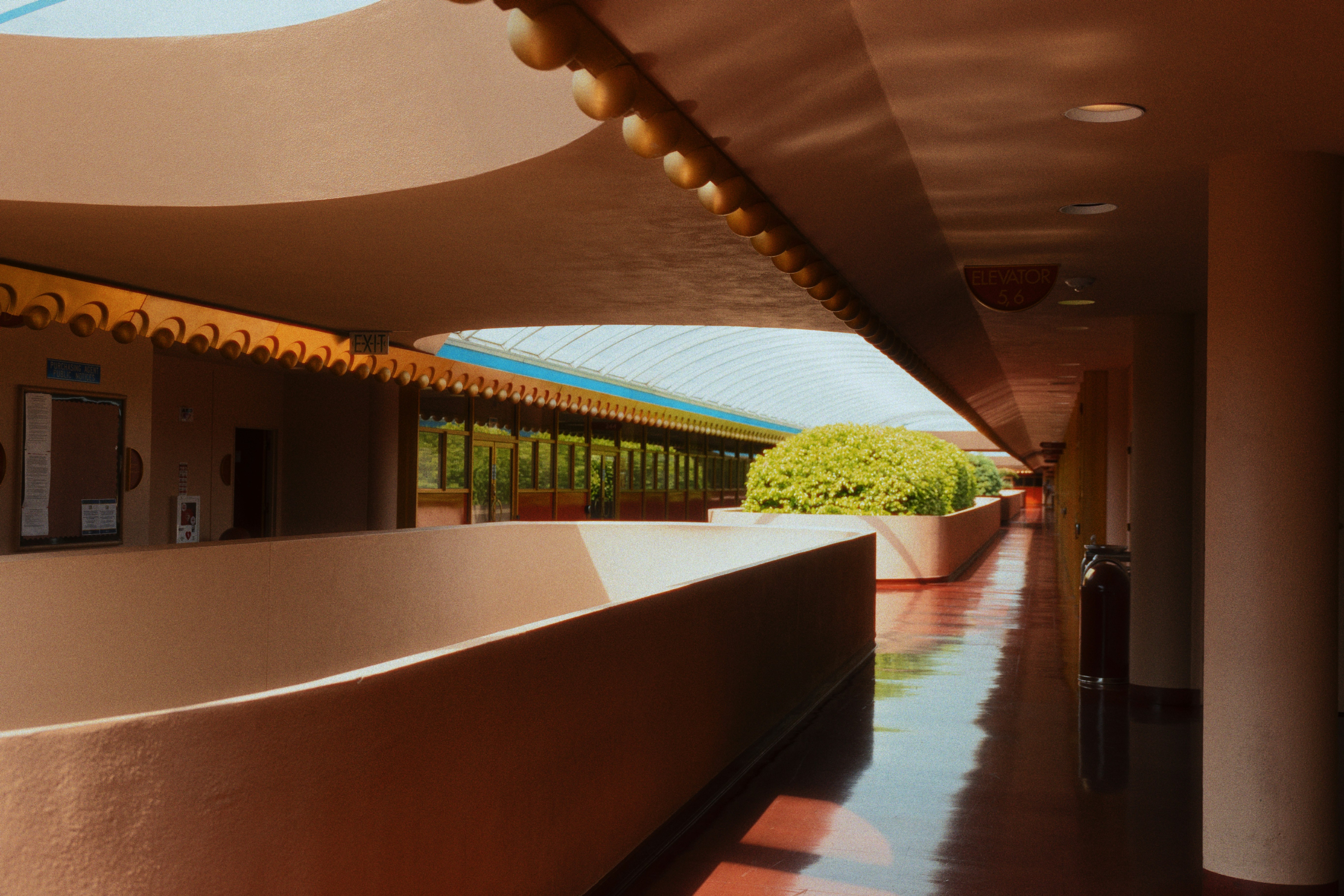 A long hallway with a clock on the wall