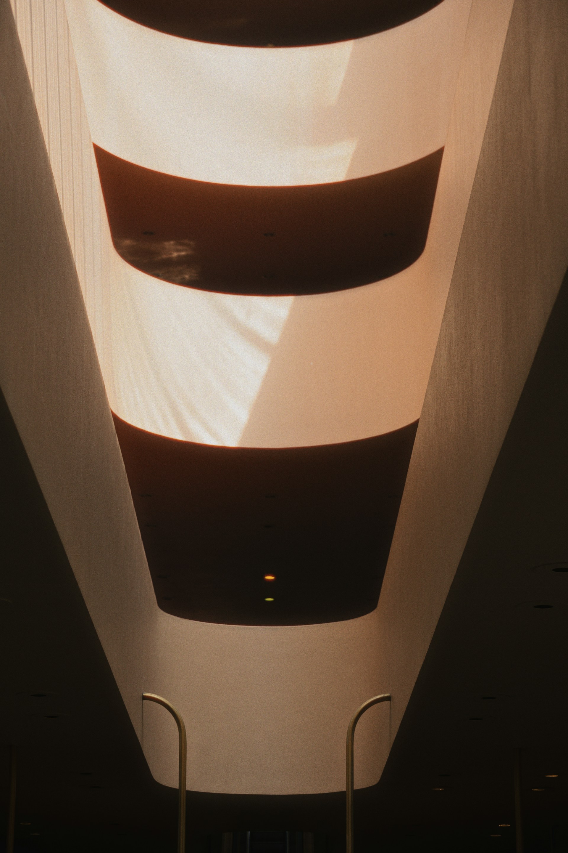 The ceiling of a building with a light shining on it