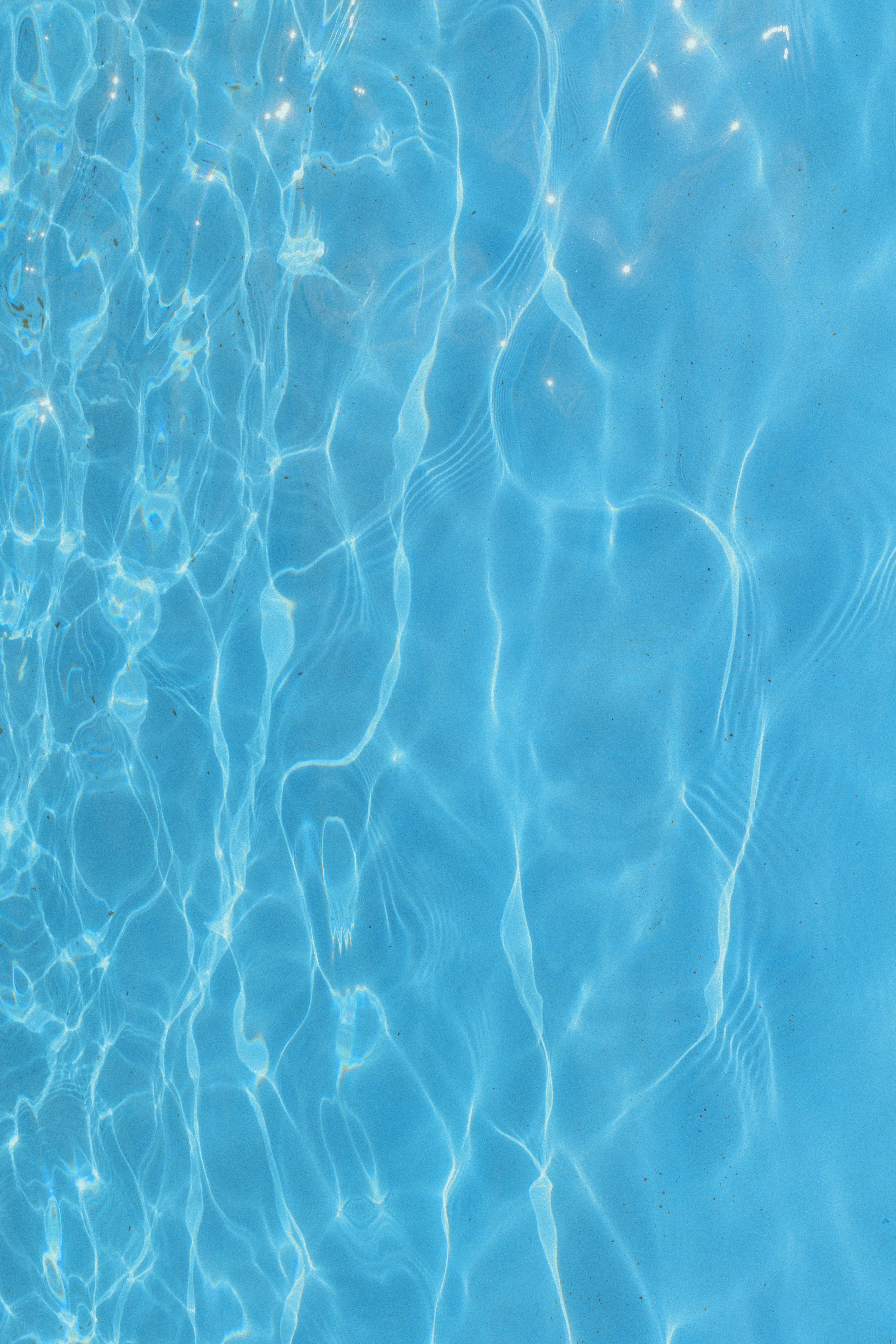A blue swimming pool with clear blue water