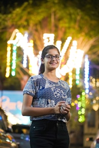 A woman standing in front of a bunch of lights