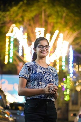 A woman standing in front of a bunch of lights