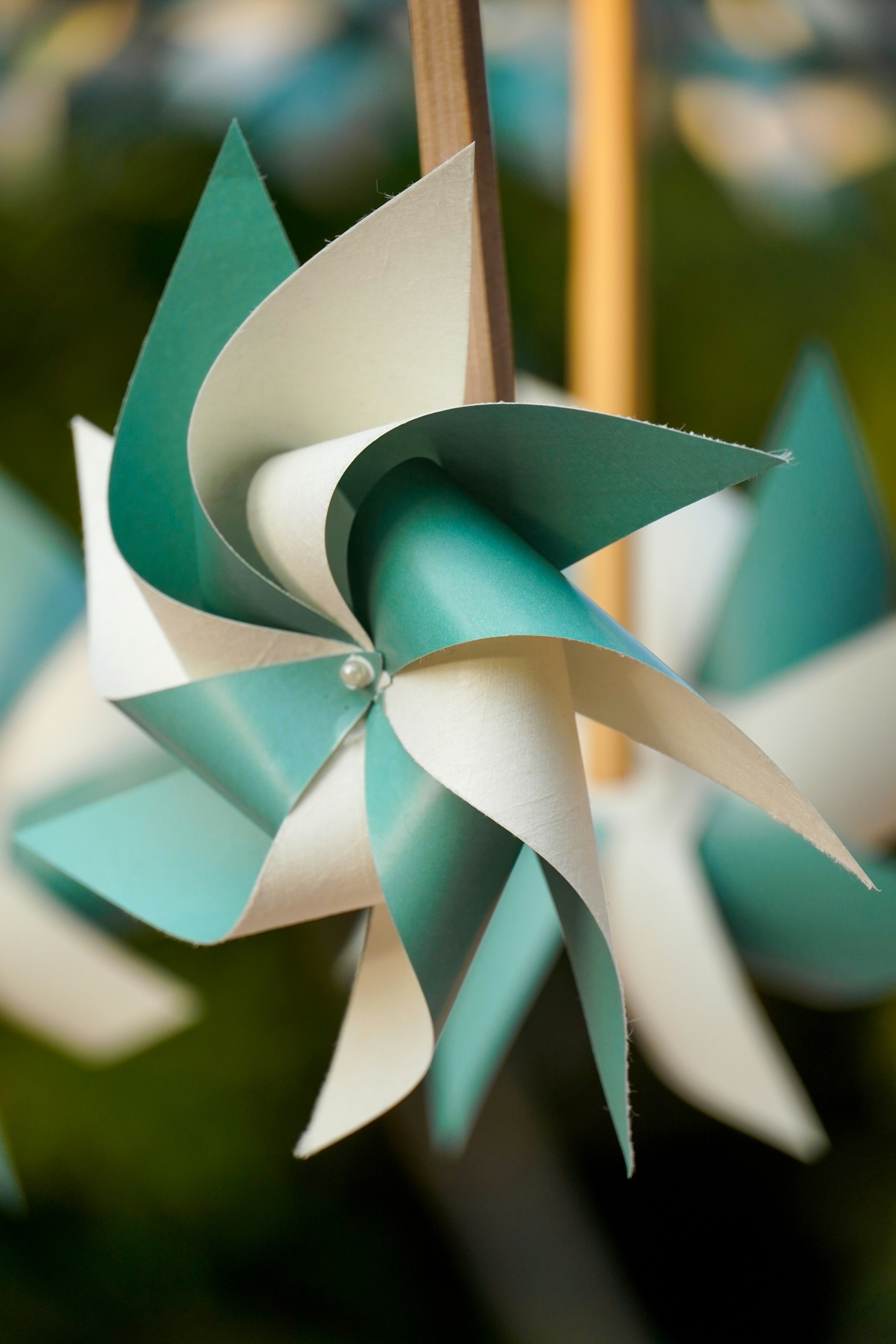 A close up of a blue and white pinwheel