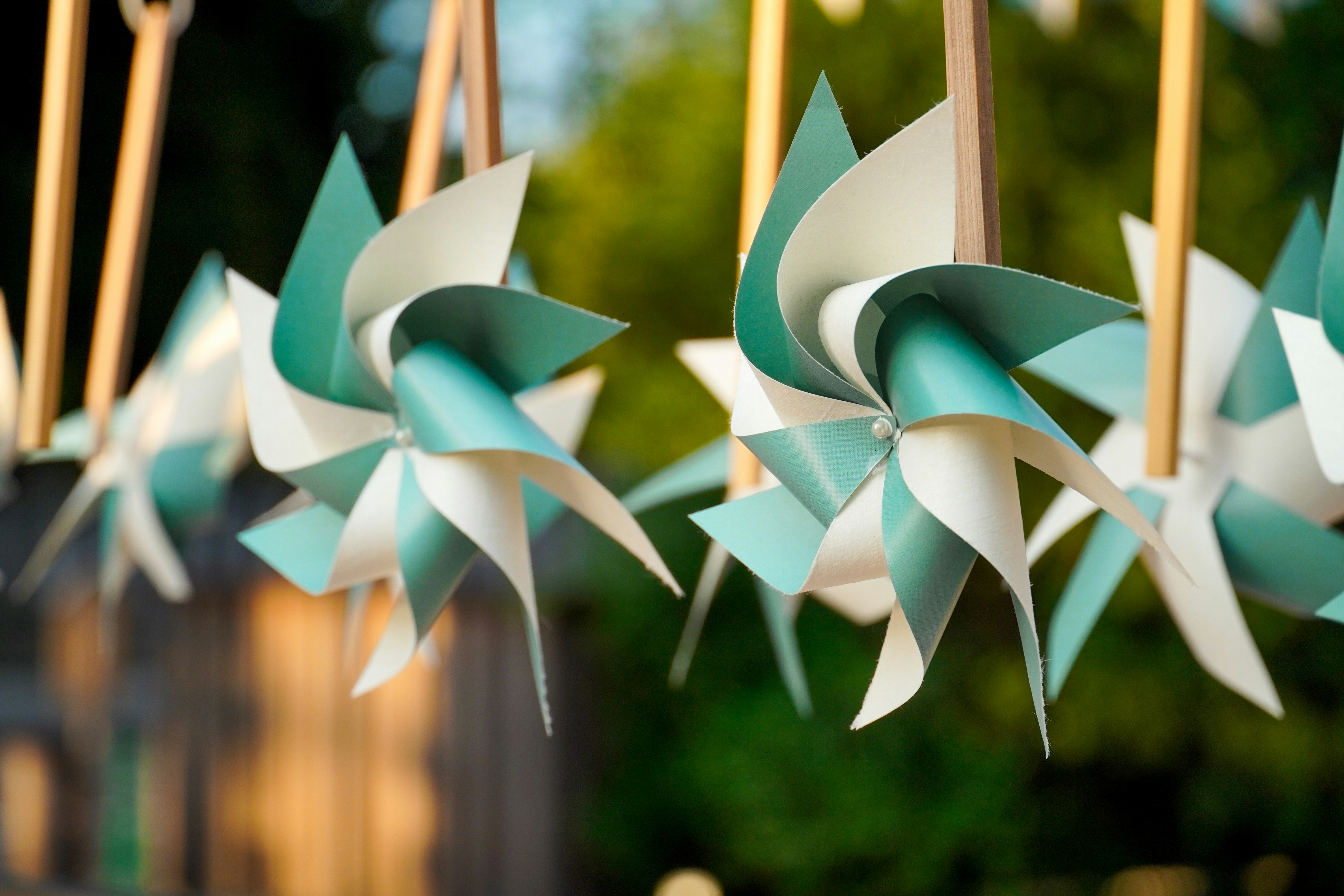 A bunch of pinwheels hanging from a line