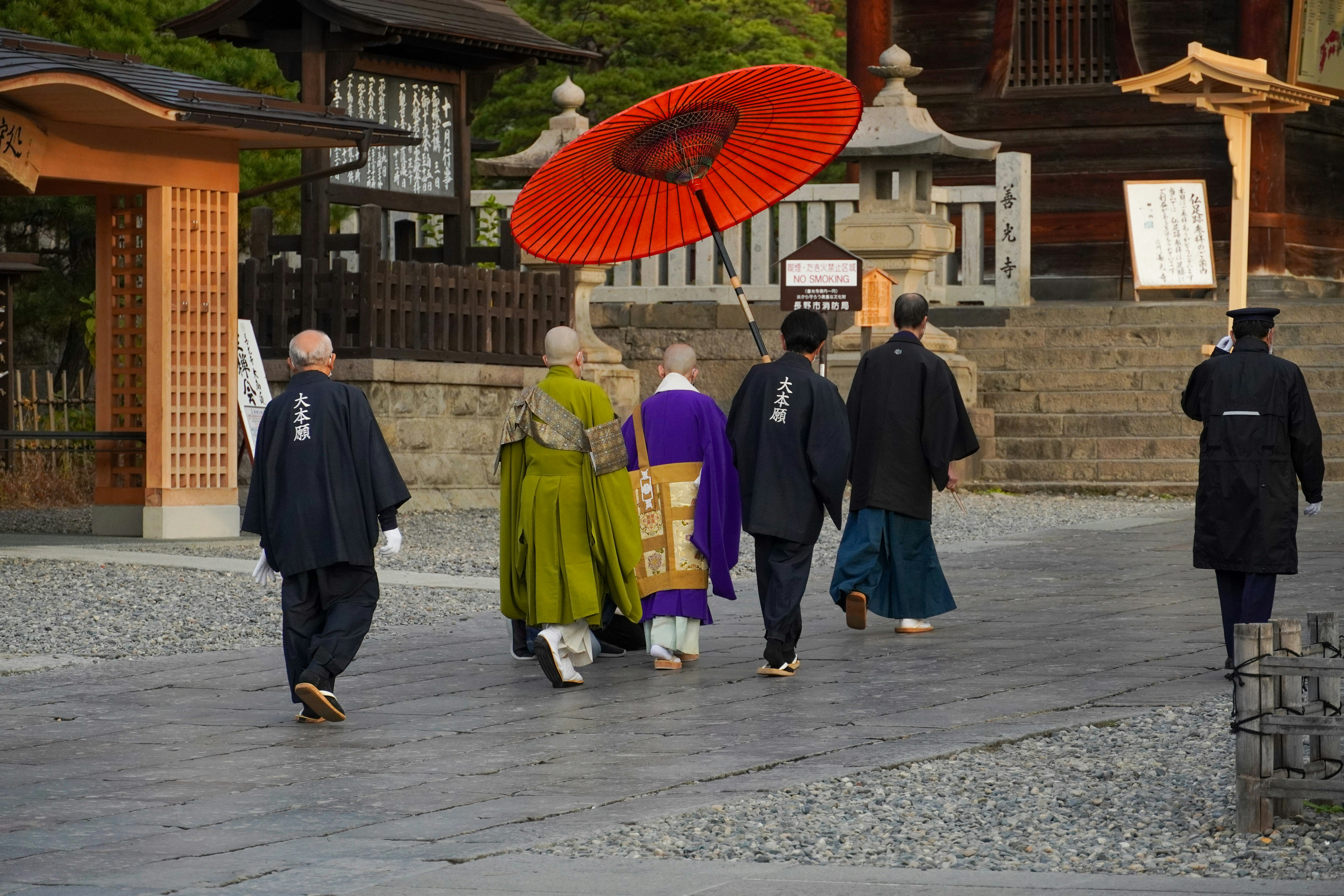 Japanese family in kimono walking towards a shrine gate for Hatsumode