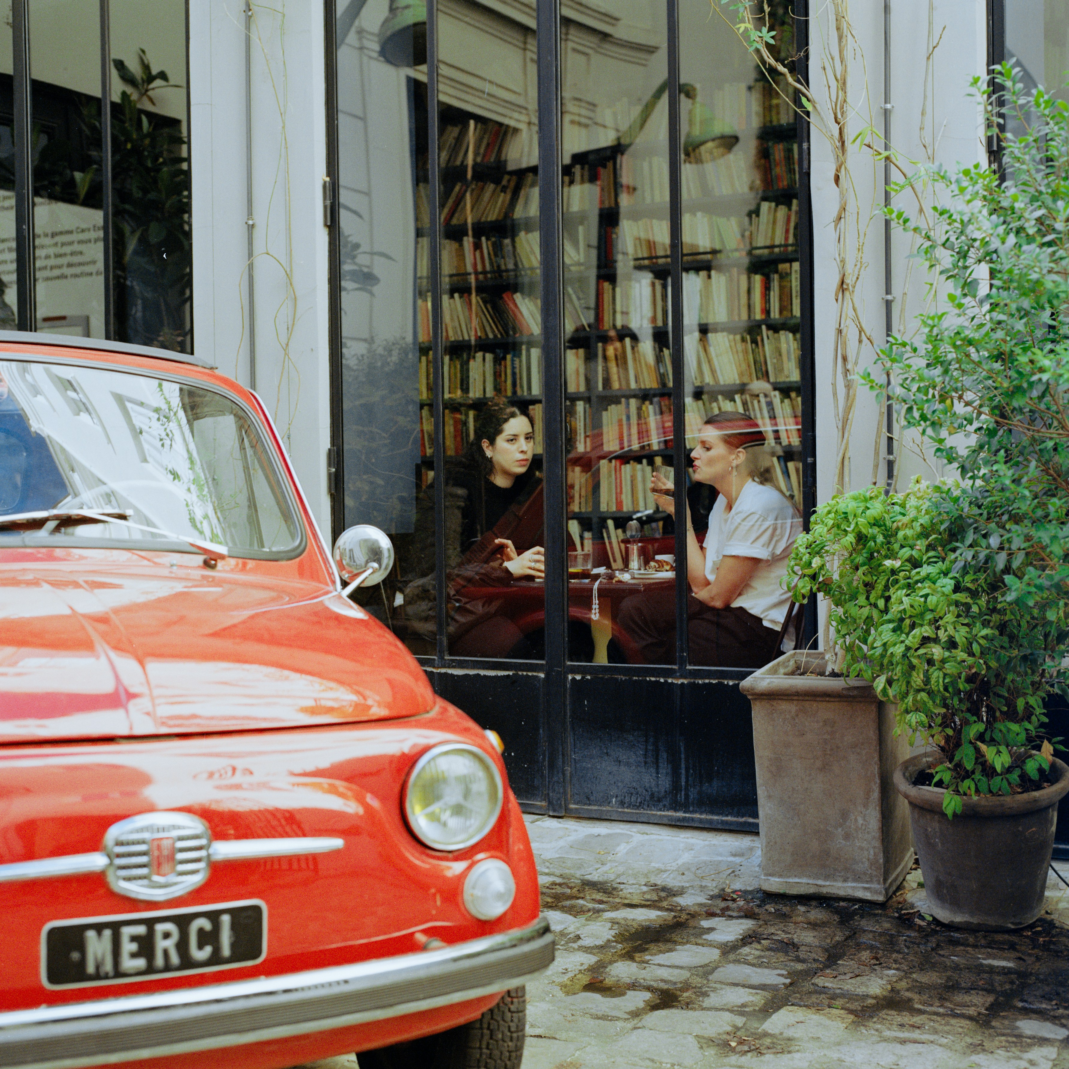 A red car parked in front of a building