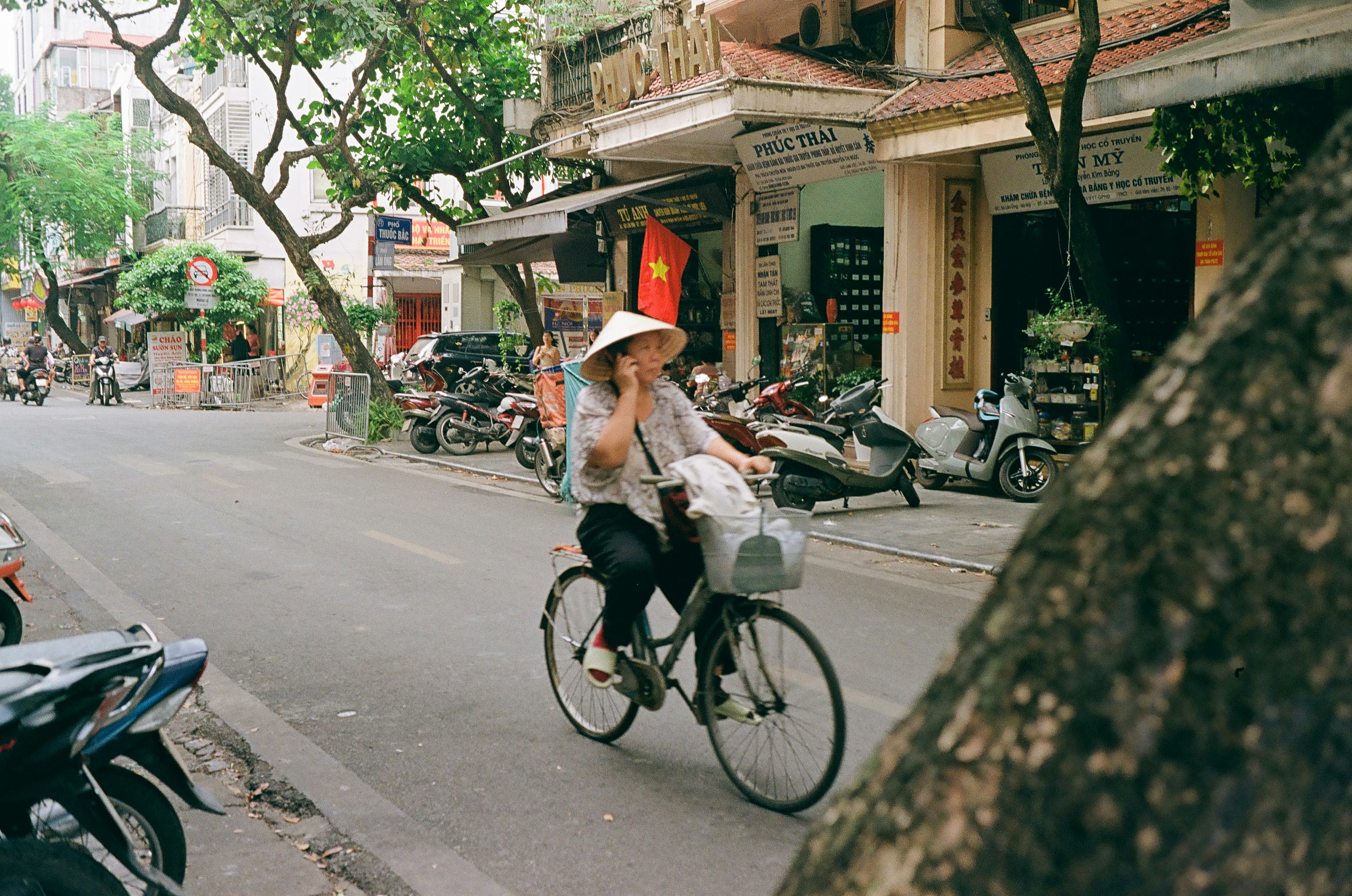 A woman riding a bike down a street
