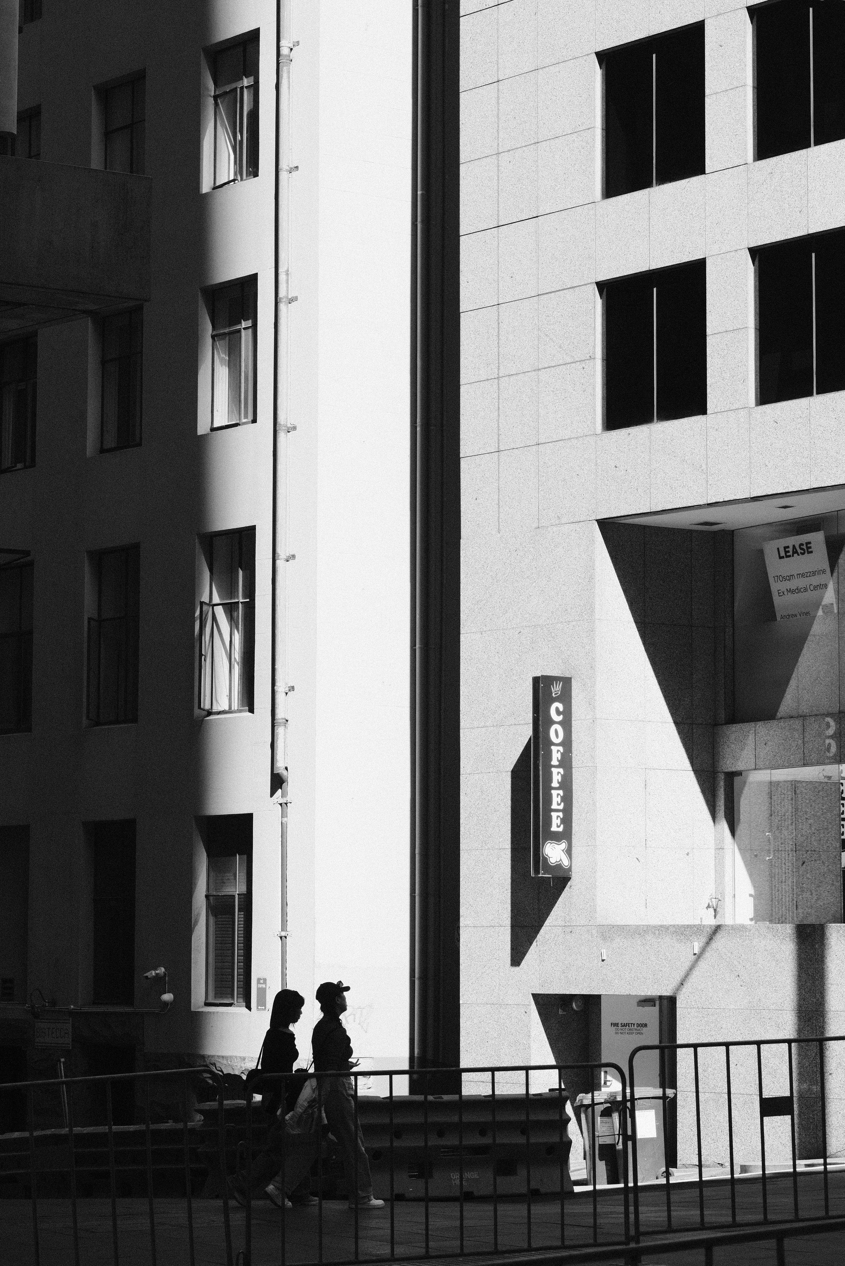 A couple of people walking across a bridge