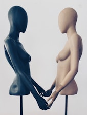 A couple of mannequins standing next to each other