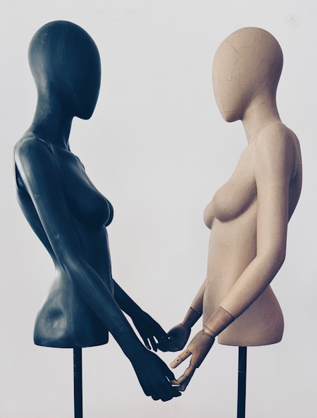 A couple of mannequins standing next to each other