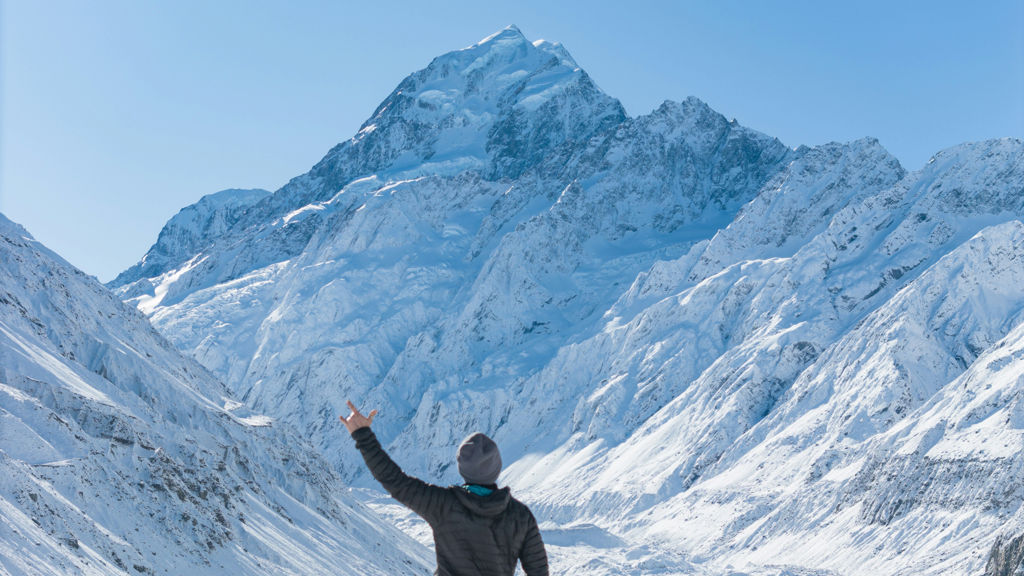 A man standing on top of a snow covered mountain, 