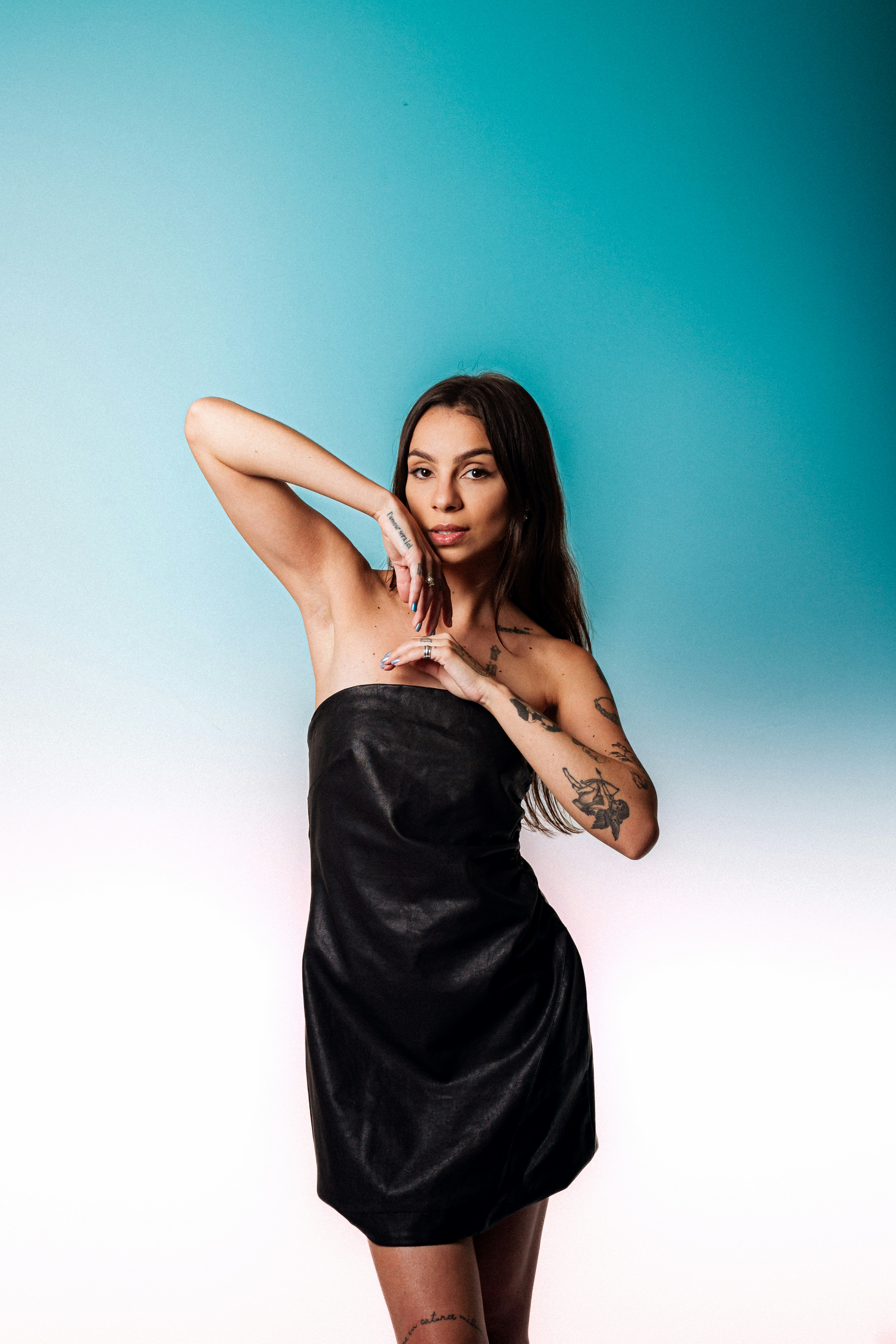 A woman in a black dress posing for a picture