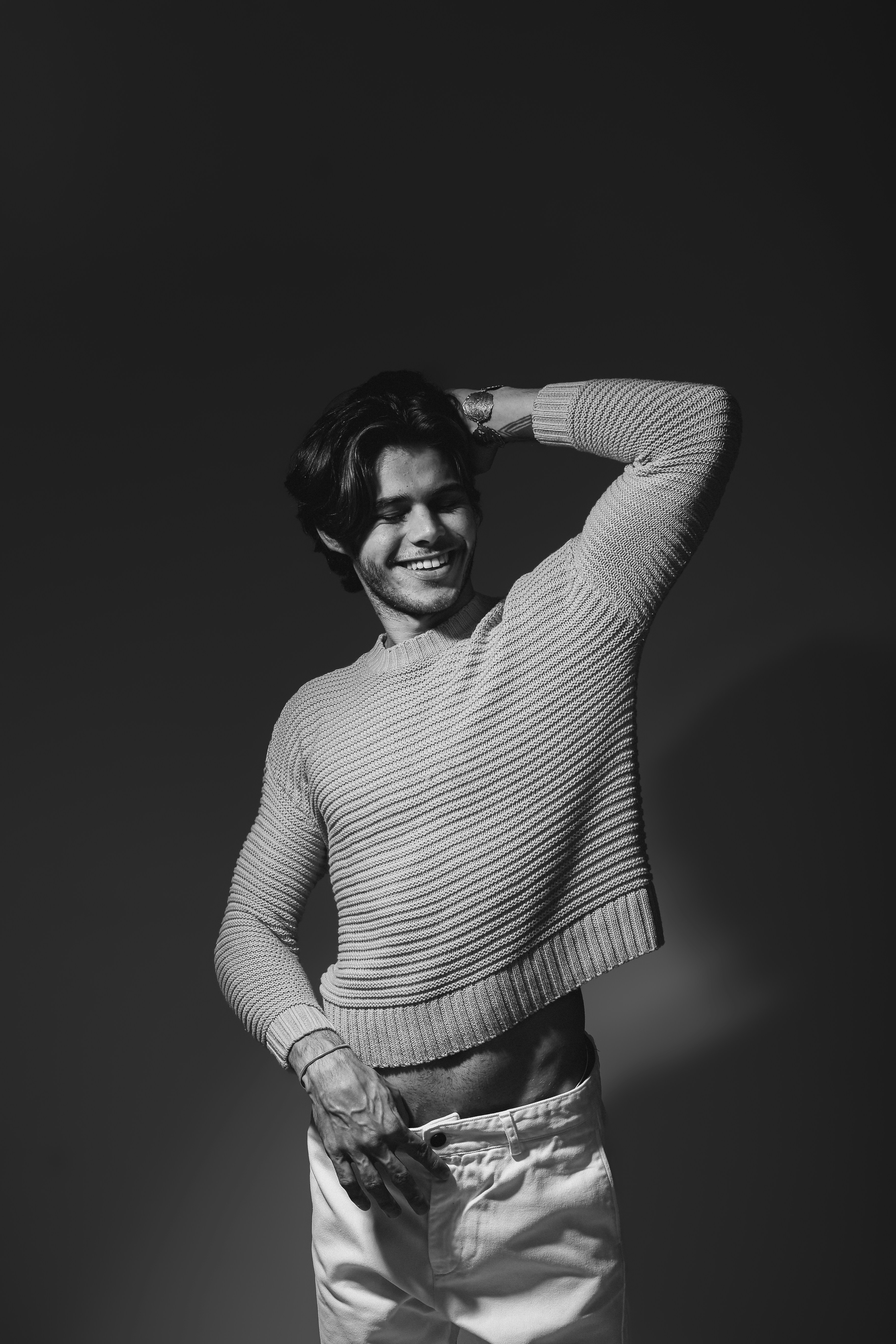 A black and white photo of a man in a sweater