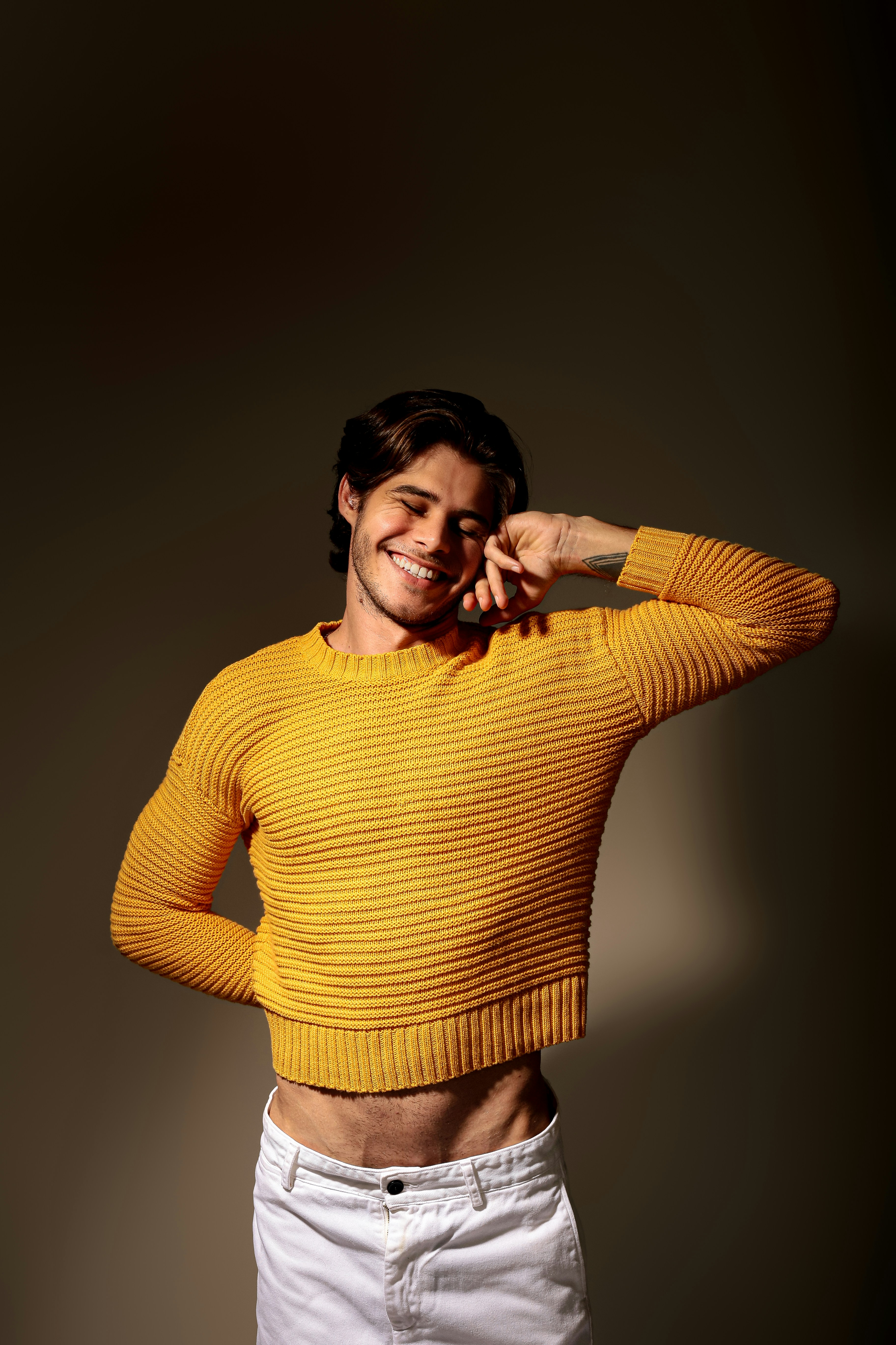 A woman in a yellow shirt posing for a picture