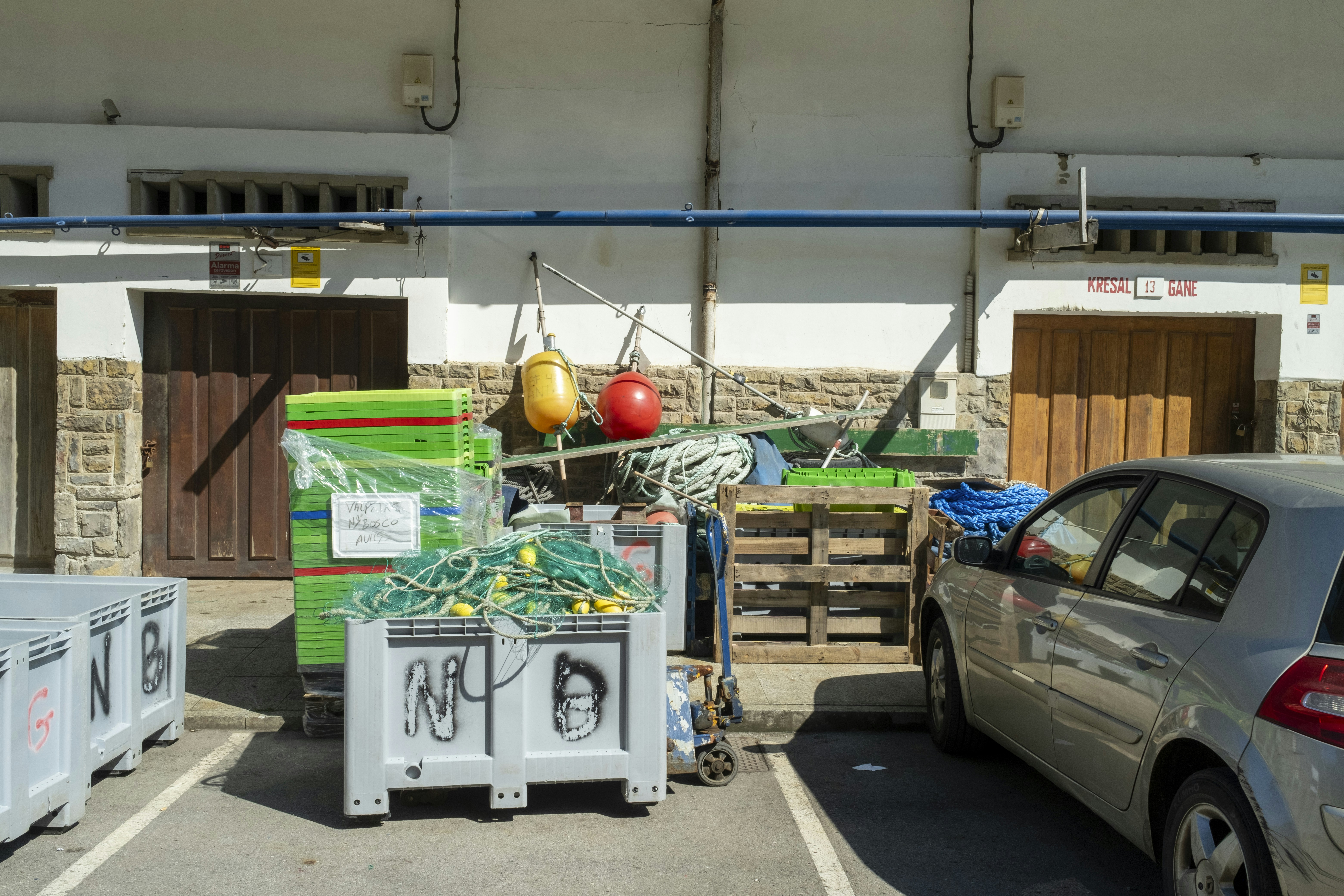 A car parked in a parking lot next to a building