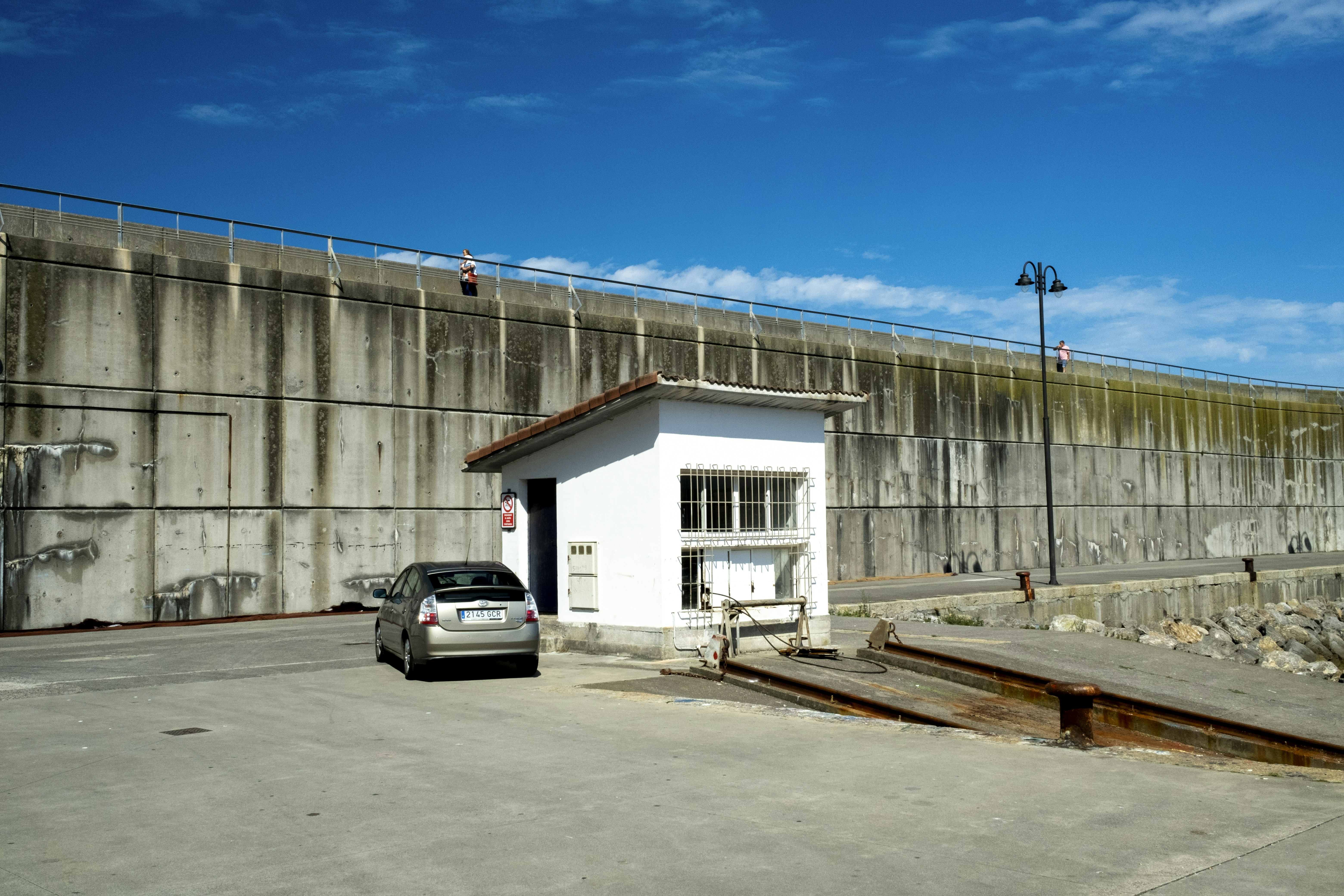 A car parked in front of a building under construction