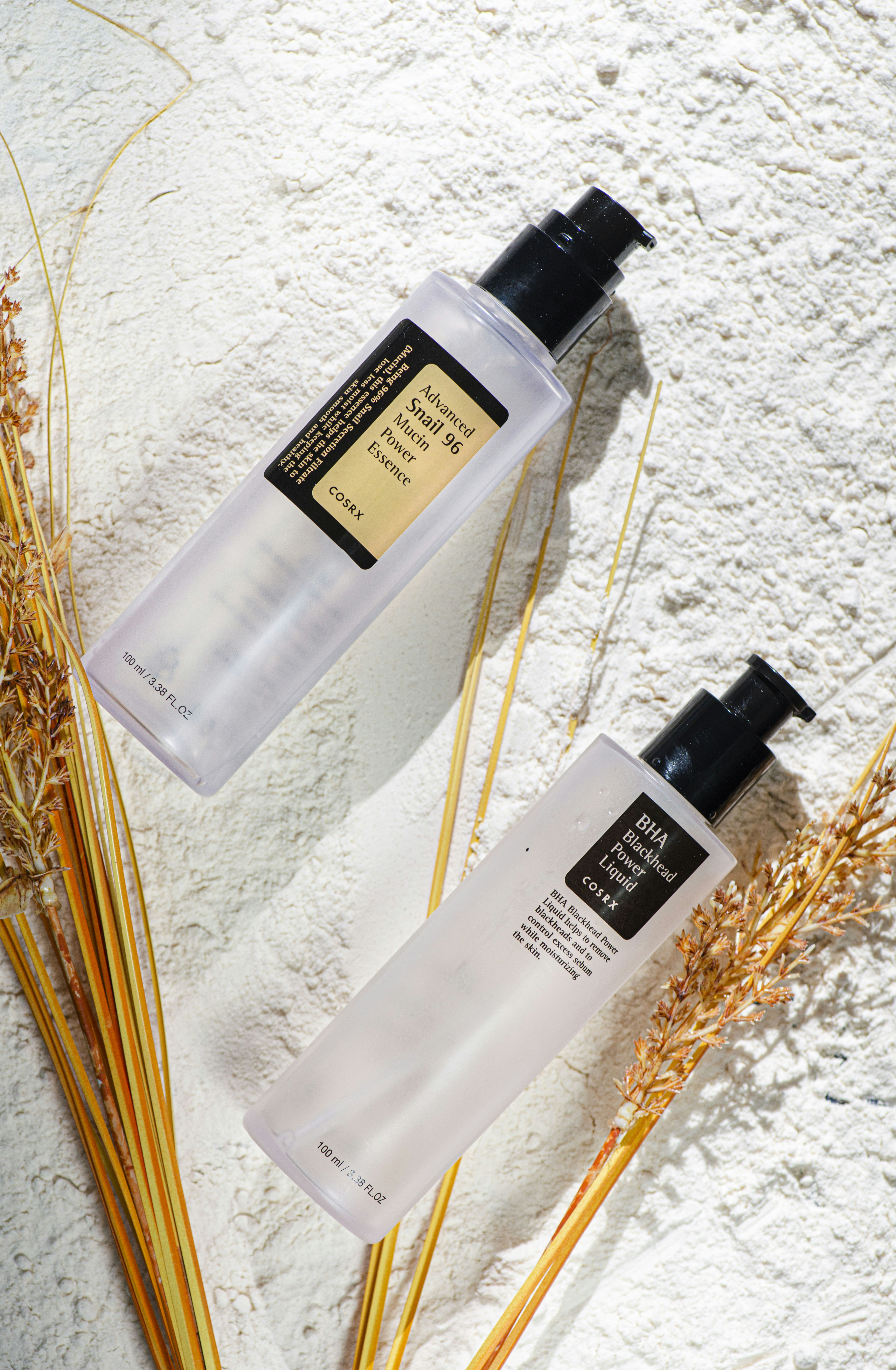 A couple of bottles of lotion sitting on top of a table