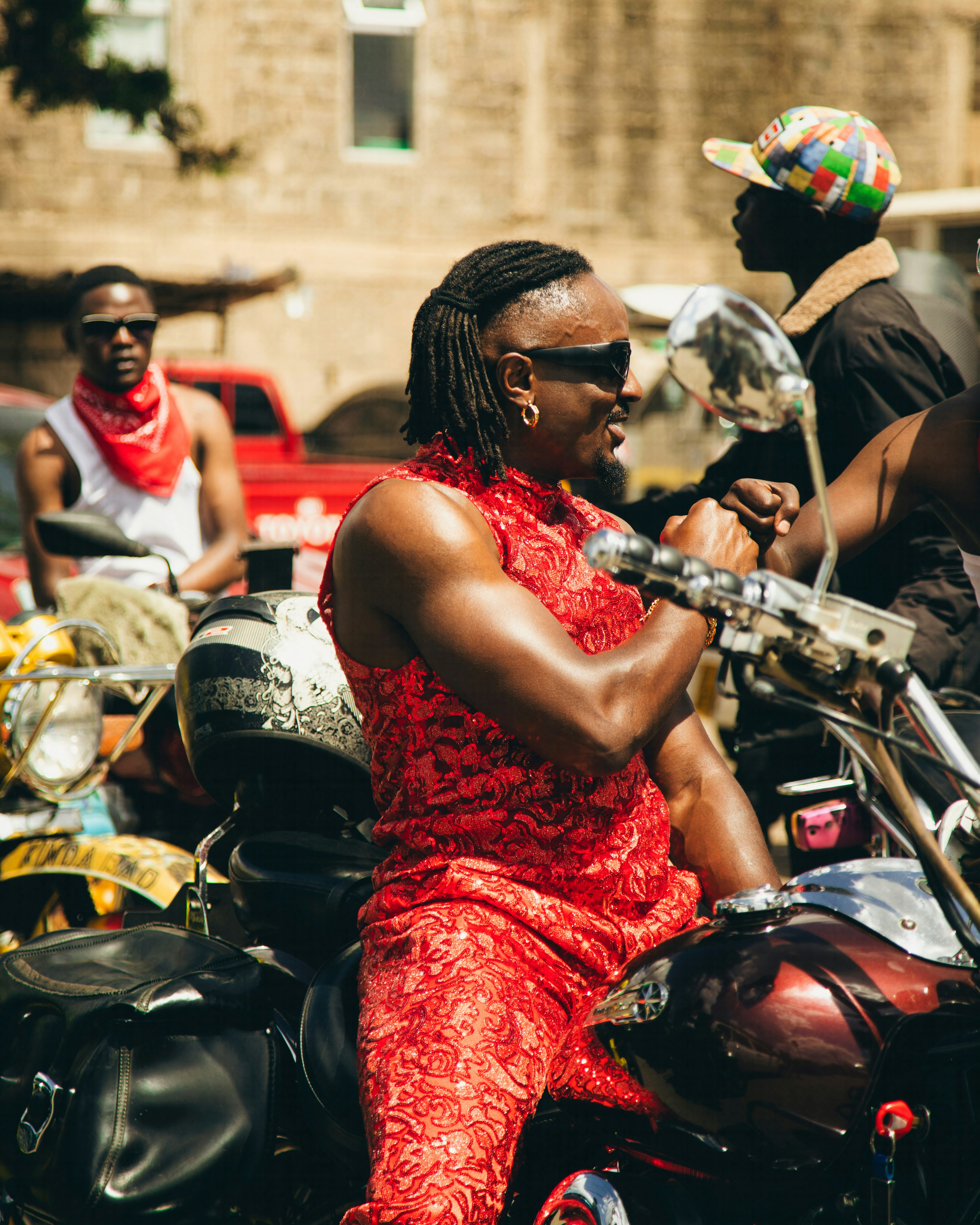 A woman in a red dress sitting on a motorcycle