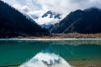 A body of water with mountains in the background