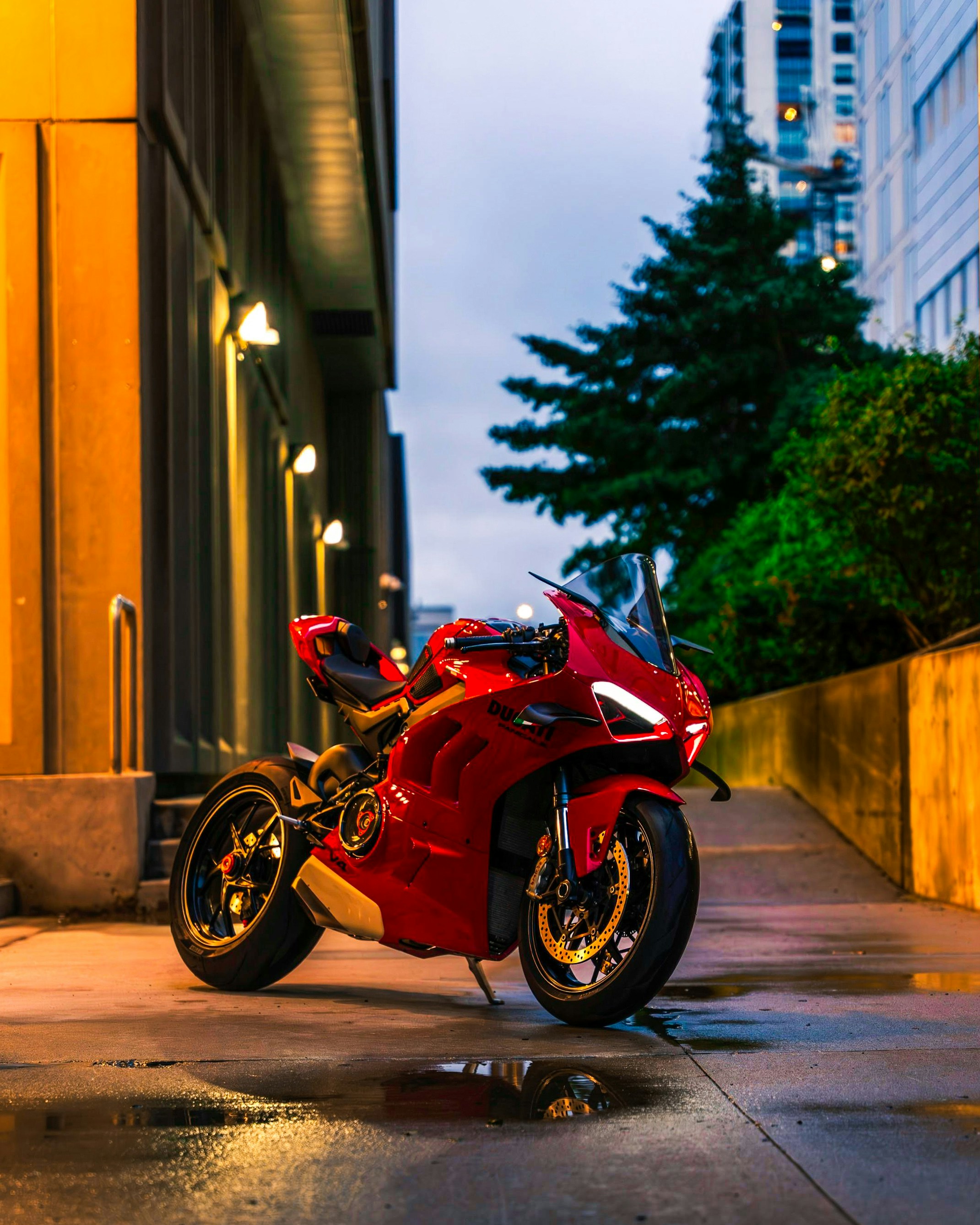 A red motorcycle parked on the side of a street