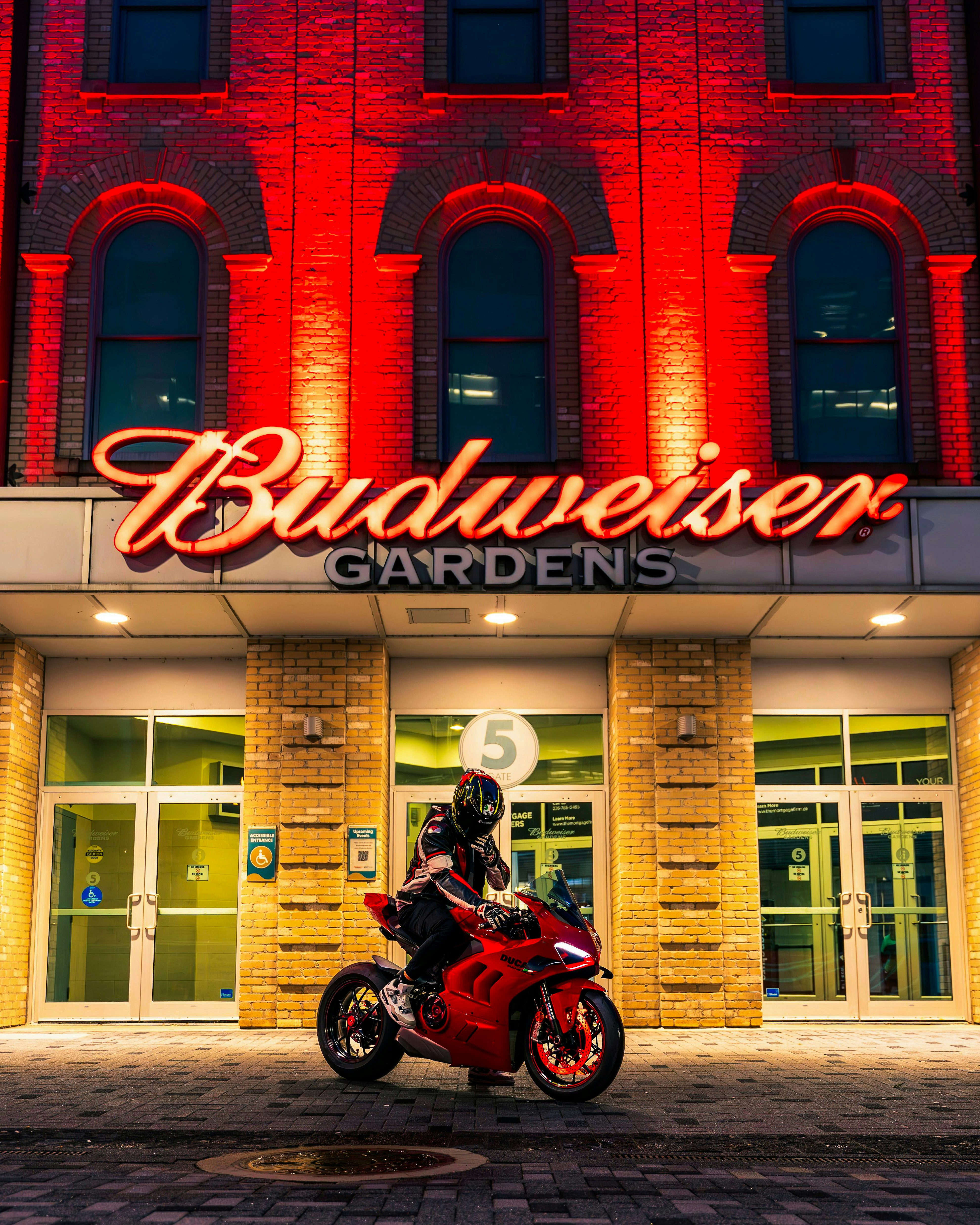 A red motorcycle parked in front of a building