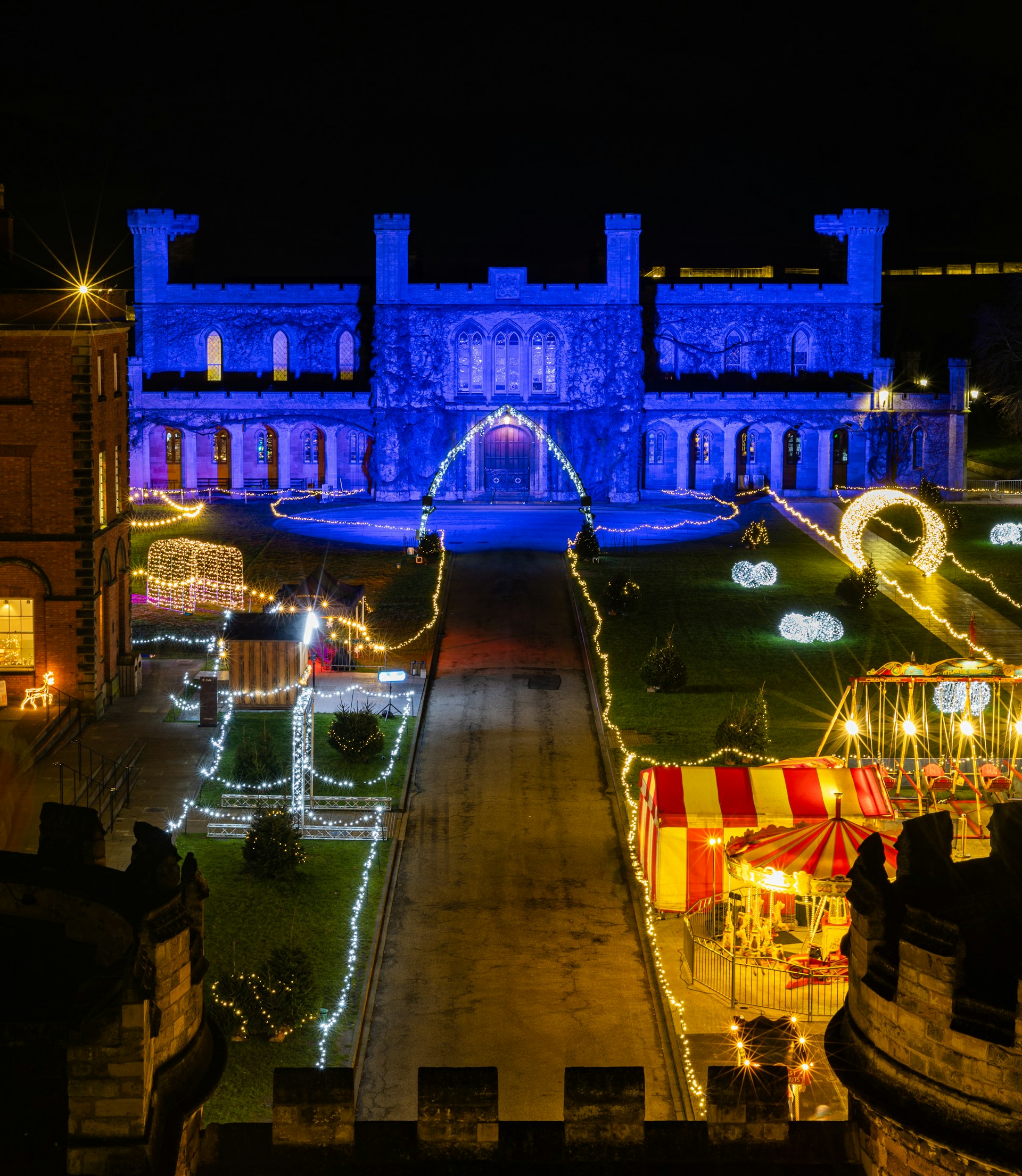 A night time view of a large building with lights on it