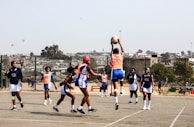 A group of young men playing a game of basketball