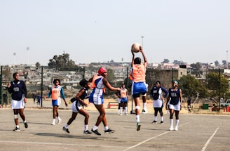 A group of young men playing a game of basketball