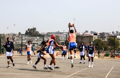 A group of young men playing a game of basketball