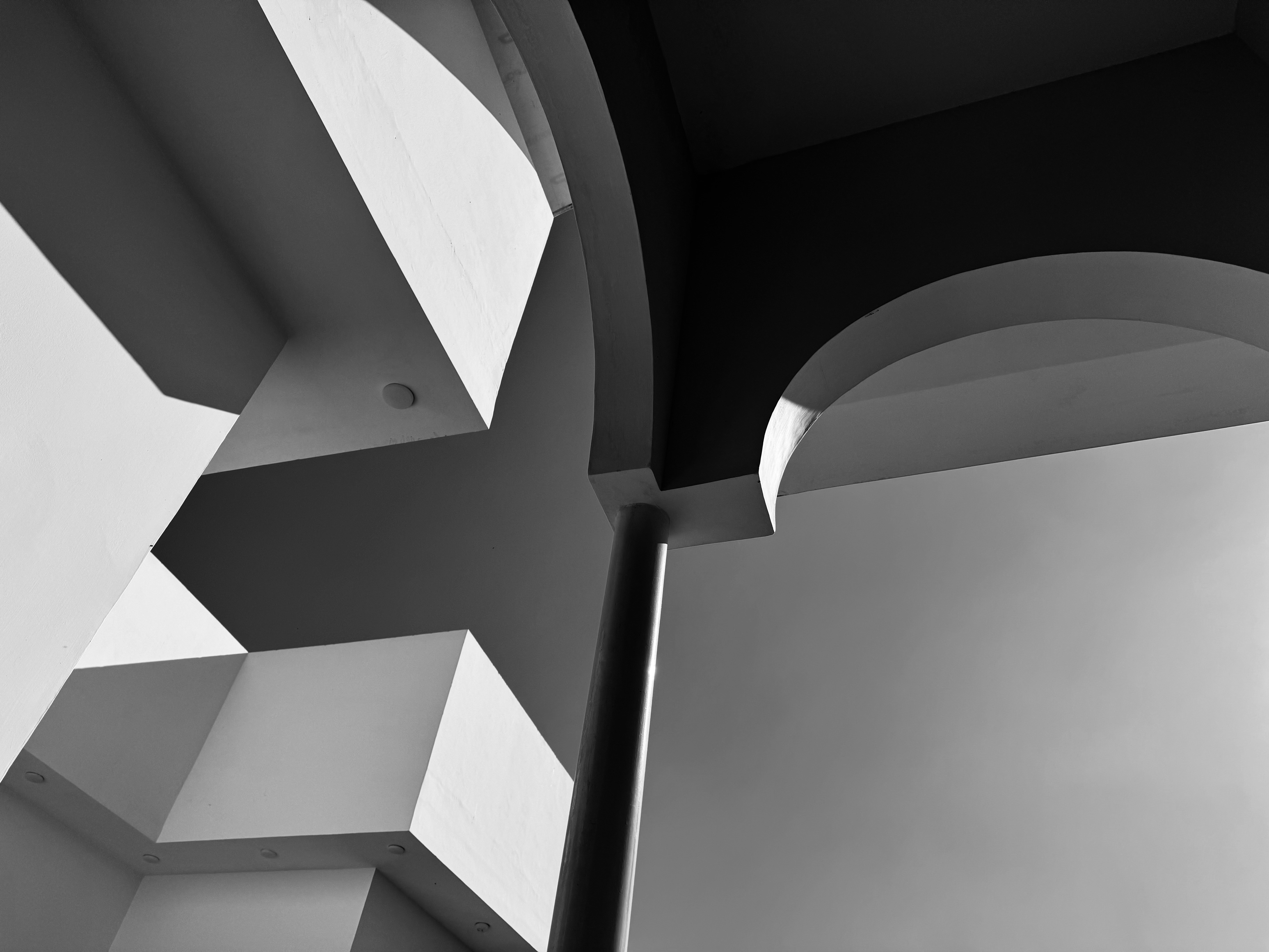 Artistic film still showing abstract architectural elements with dramatic shadow play