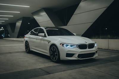 A white car parked in a parking garage