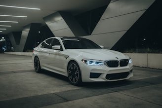 A white car parked in a parking garage