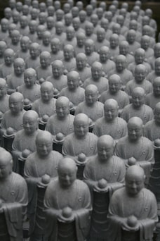 A large group of buddha statues sitting next to each other