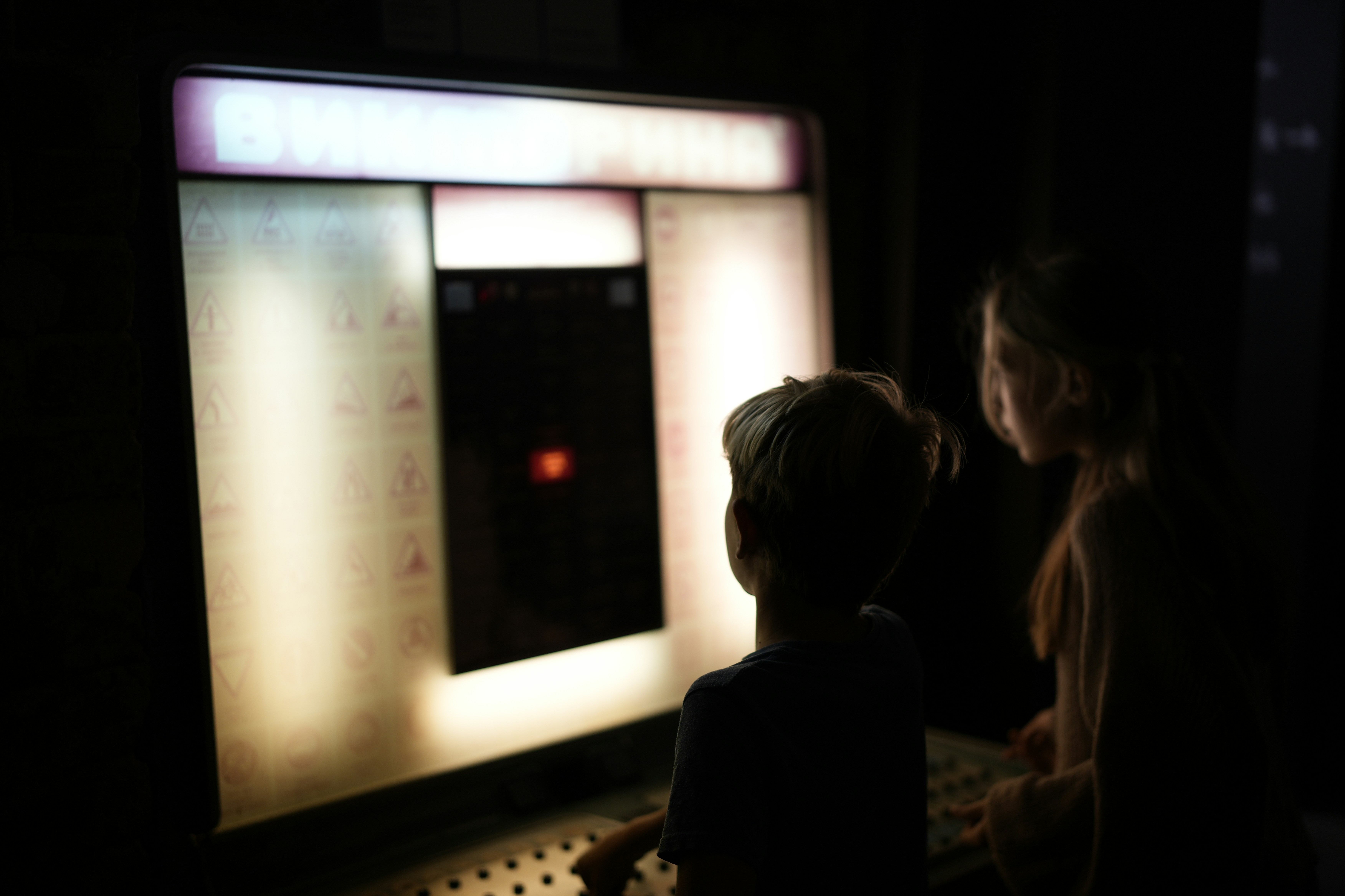 A couple of people standing in front of a screen