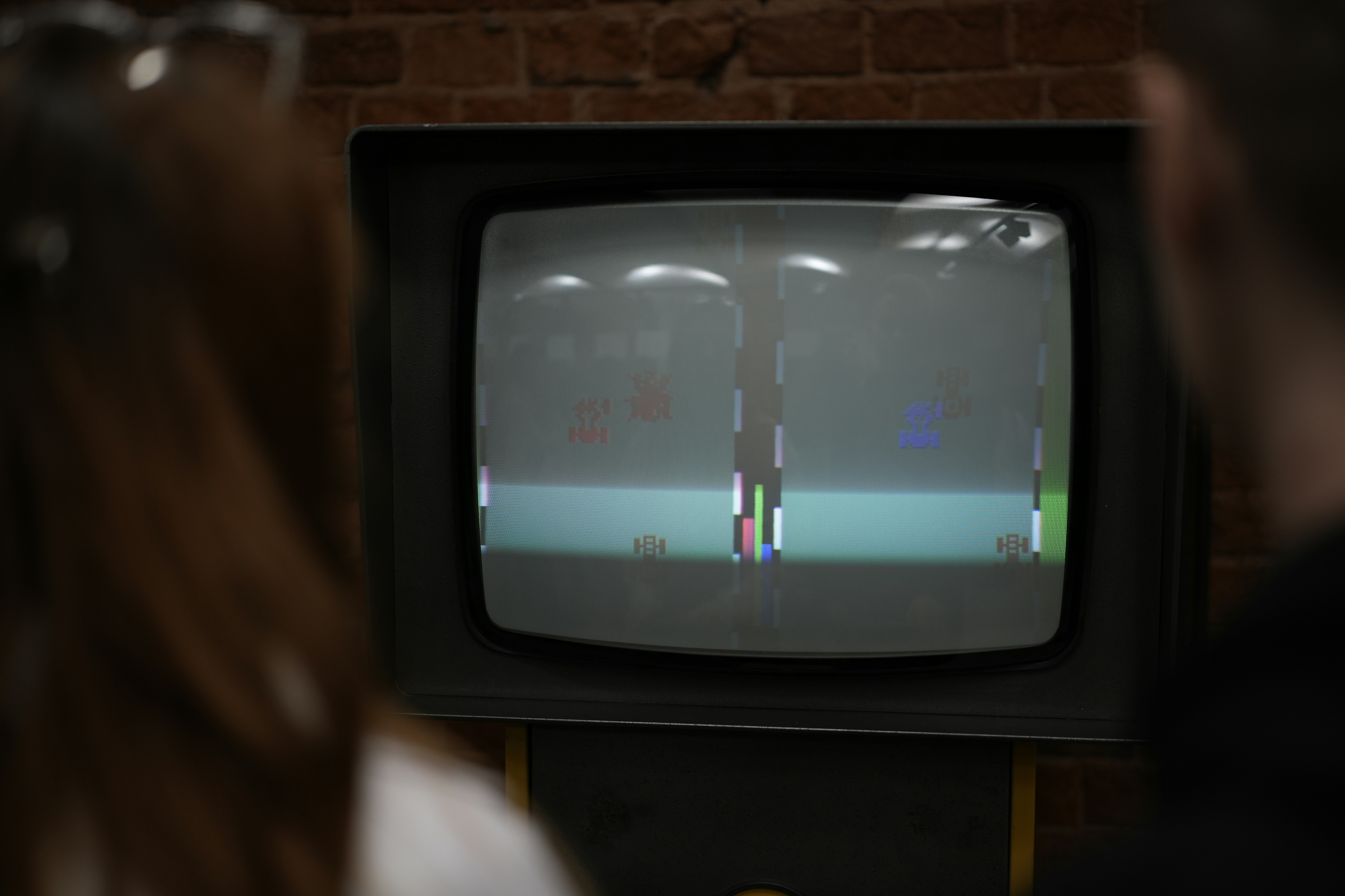 Person standing in front of a TV