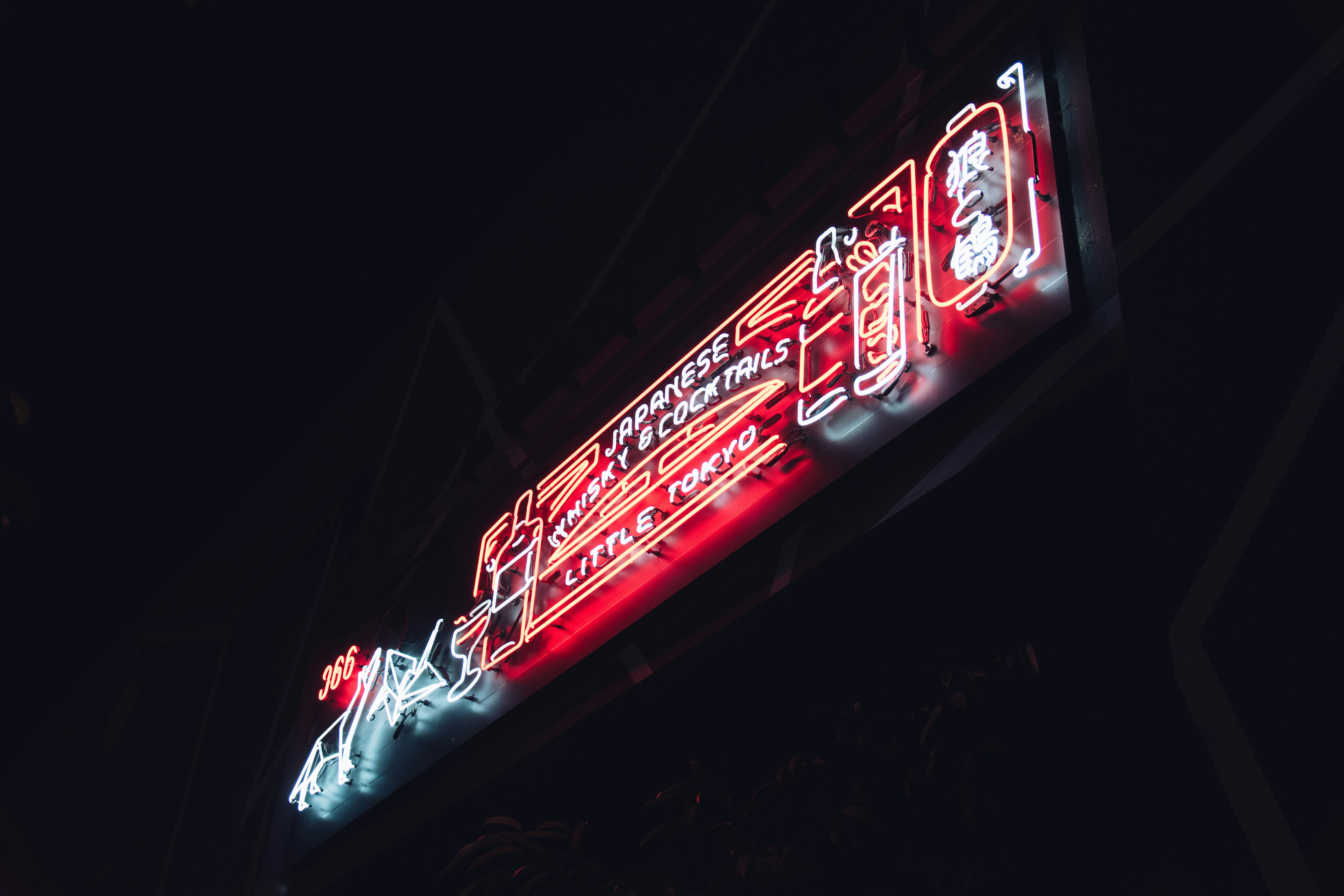 A neon sign on the side of a building