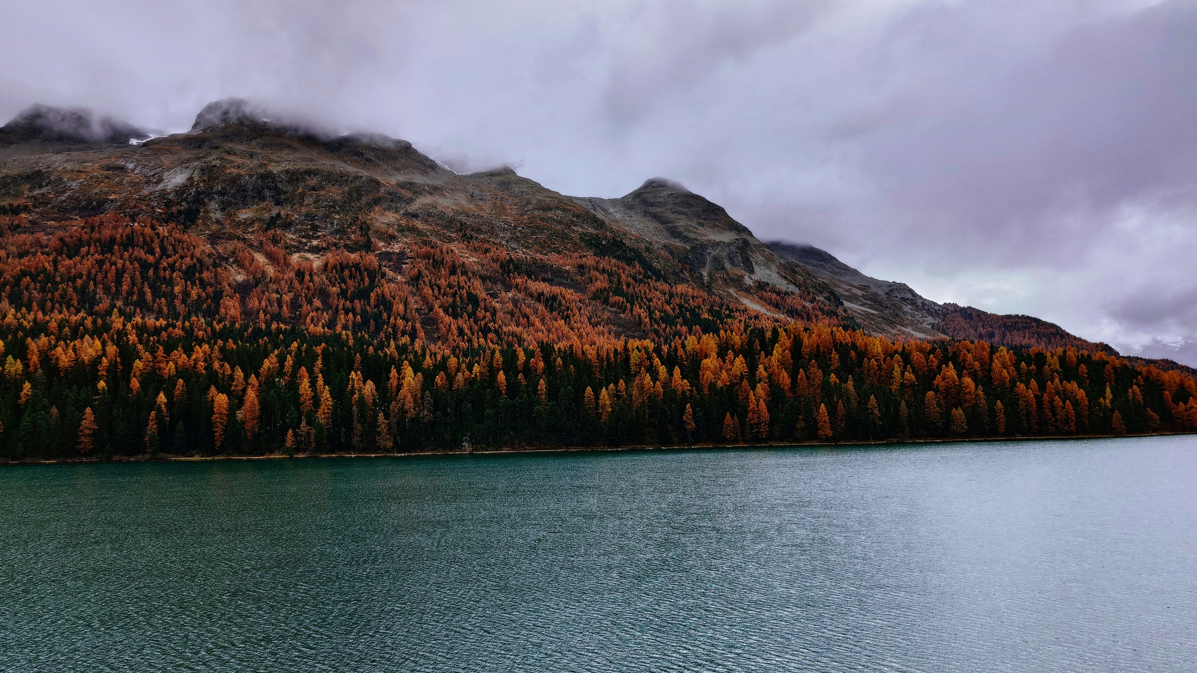 A large body of water with a mountain in the background
