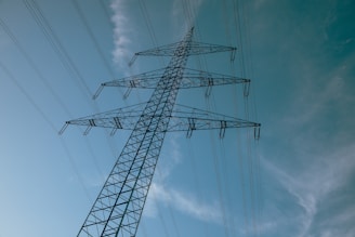 A high voltage power line against a blue sky