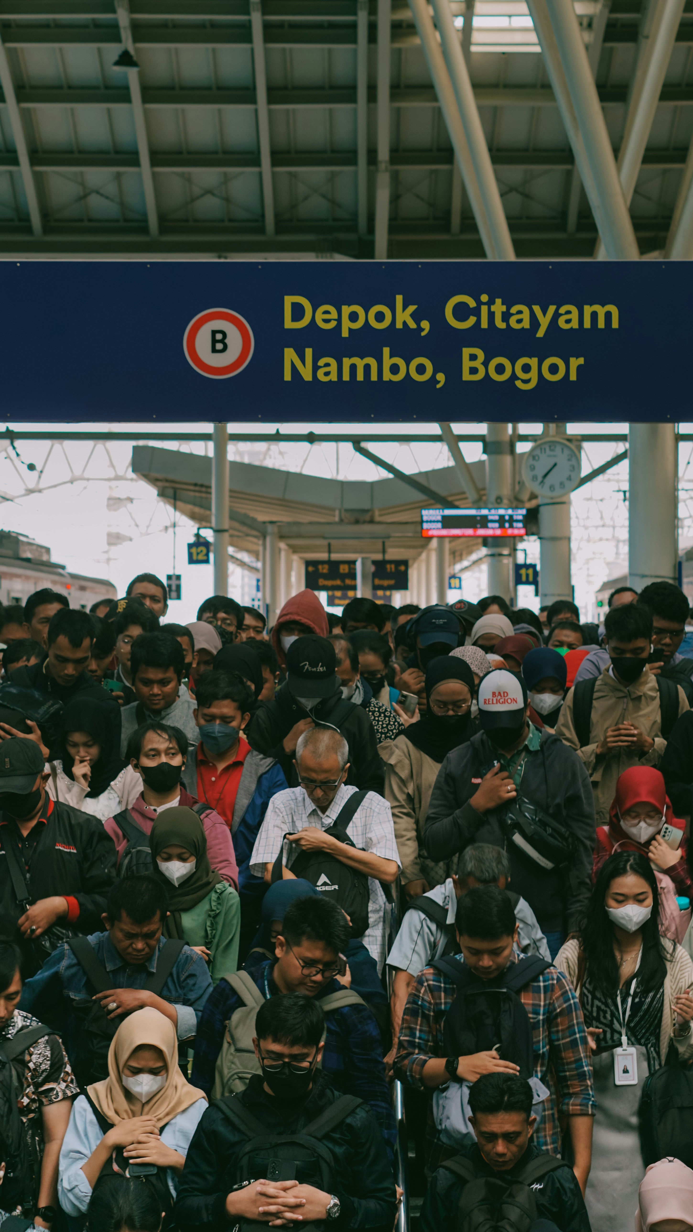 A large group of people standing in front of a train station