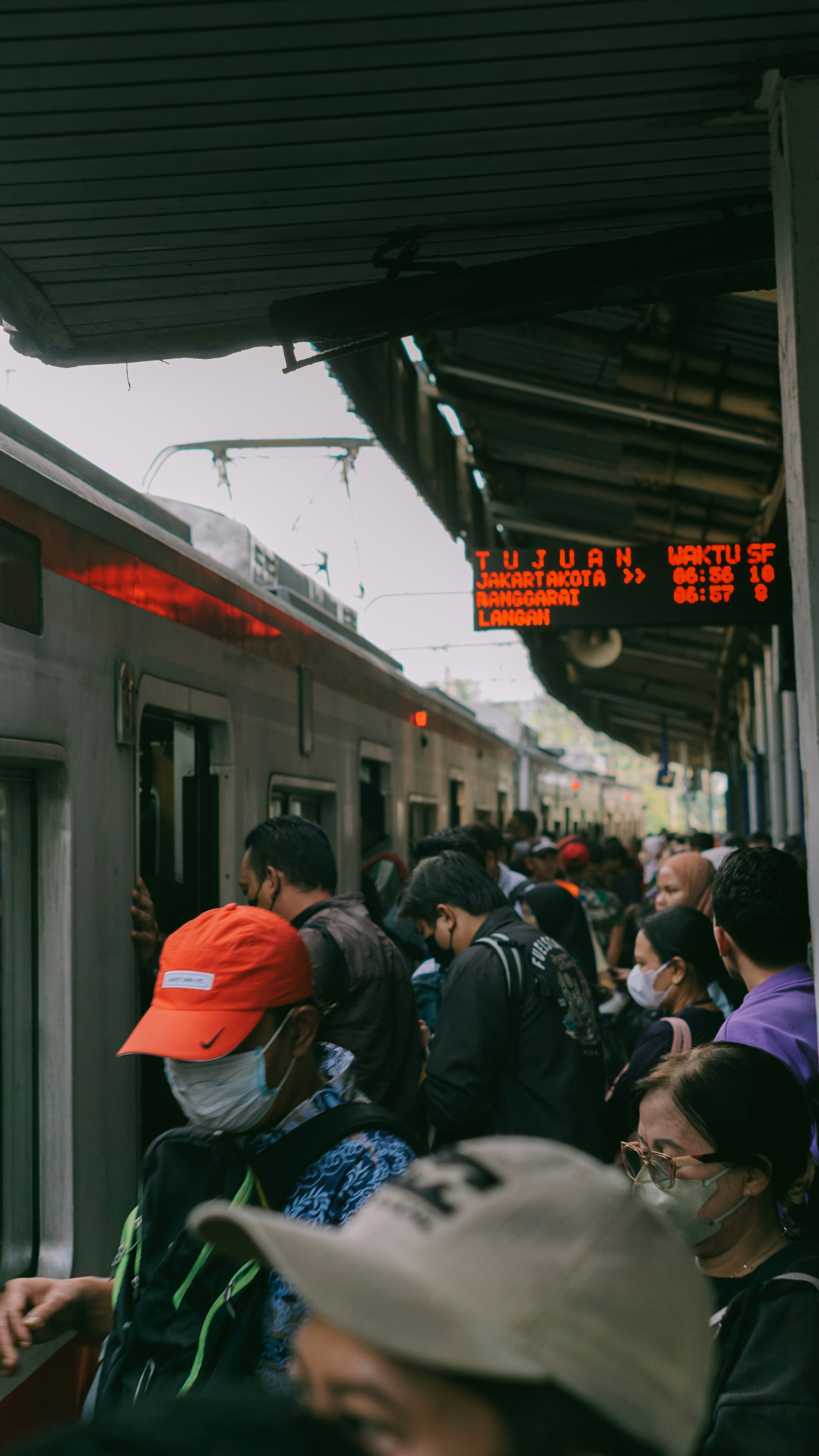 A group of people standing next to a train