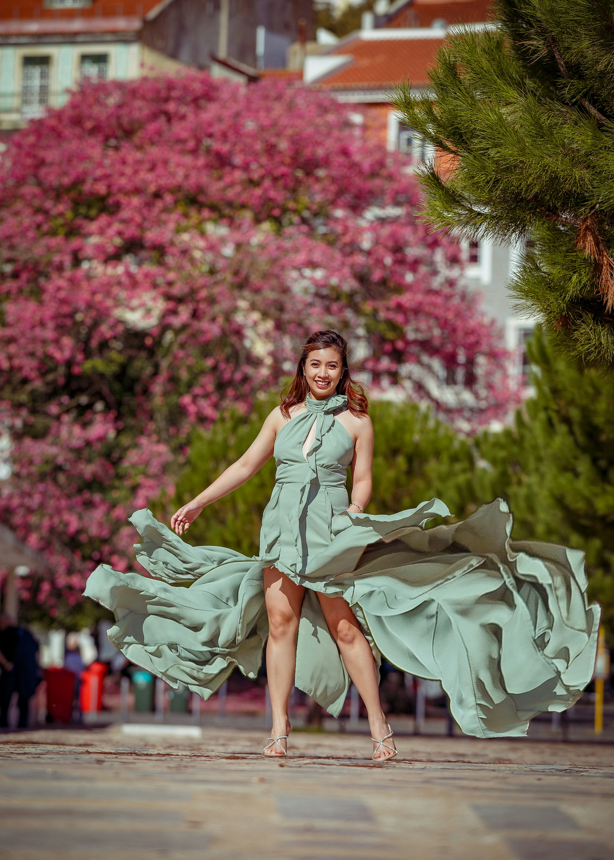 A woman in a blue dress is posing for a picture