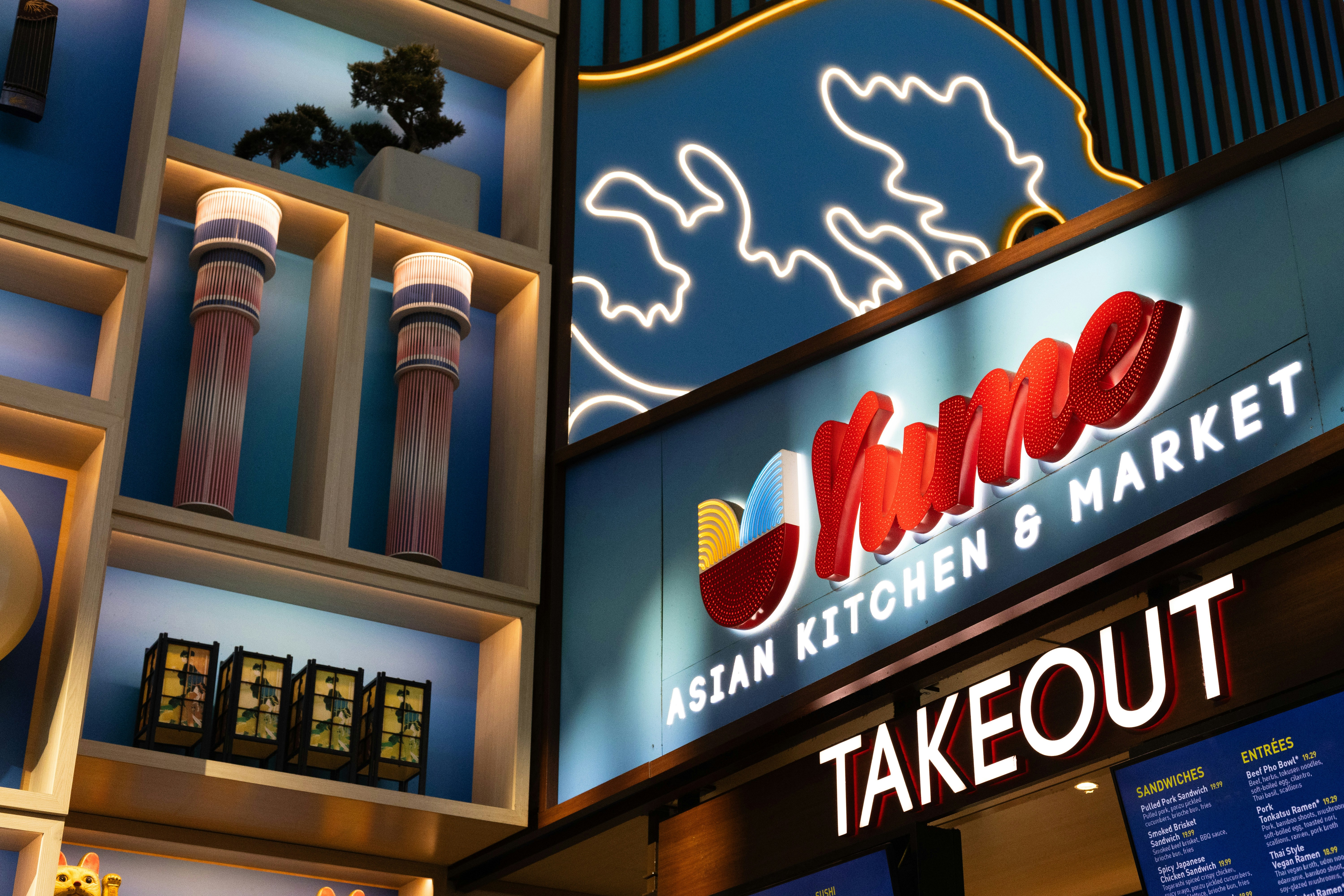 A restaurant sign is lit up at night
