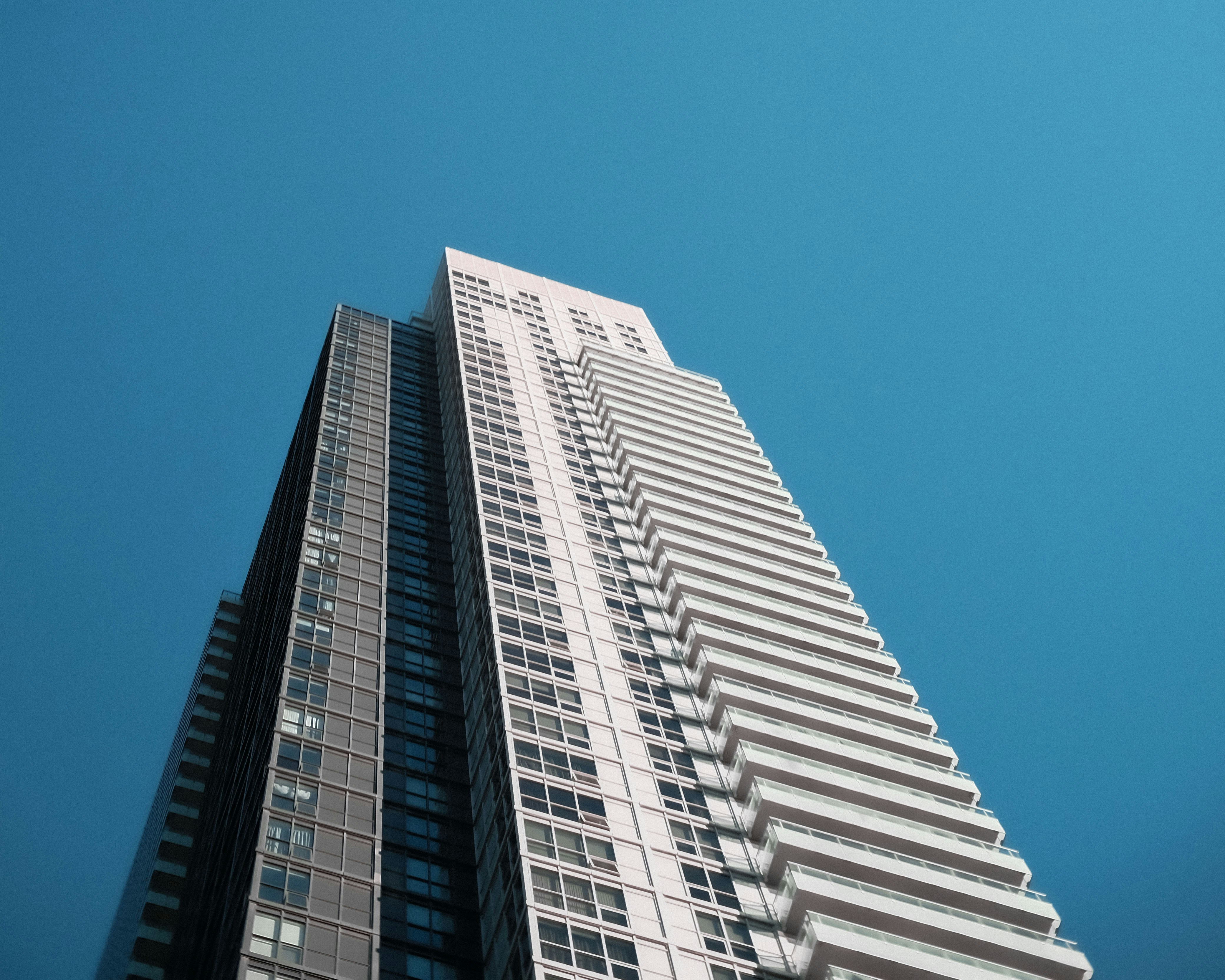 A very tall building in the middle of a clear blue sky
