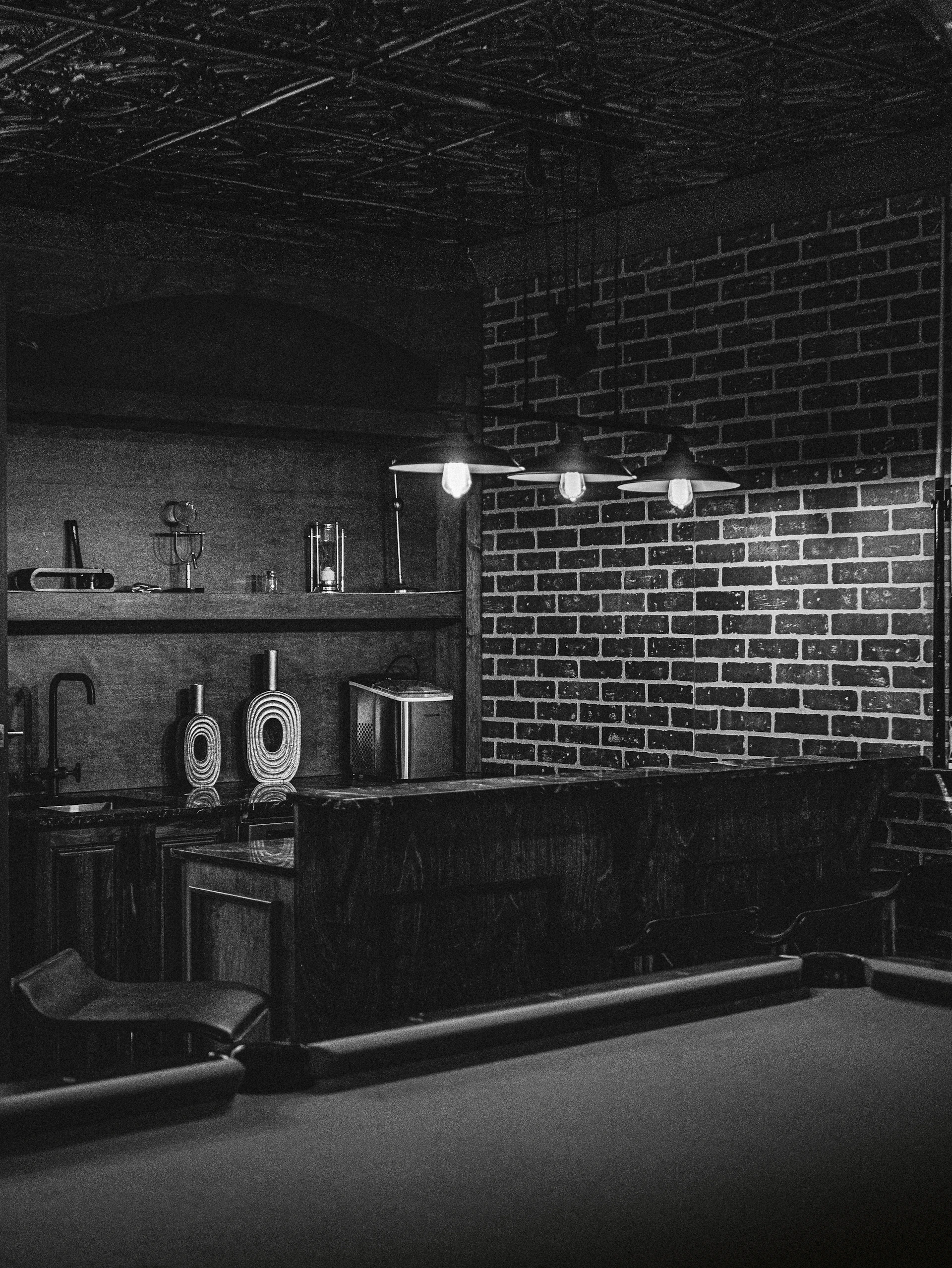 A black and white photo of a room with a pool table