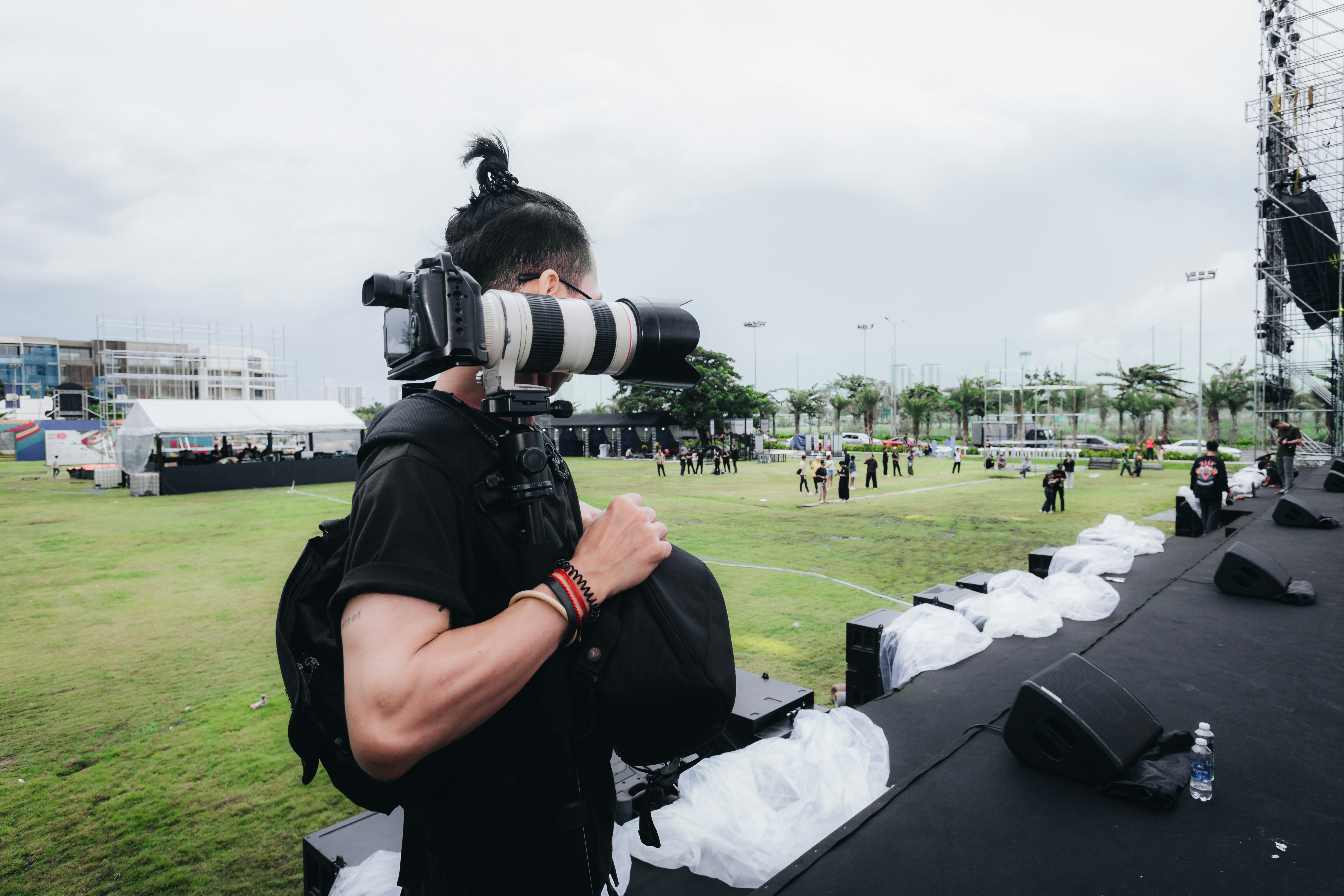 A man with a camera taking pictures of a soccer field