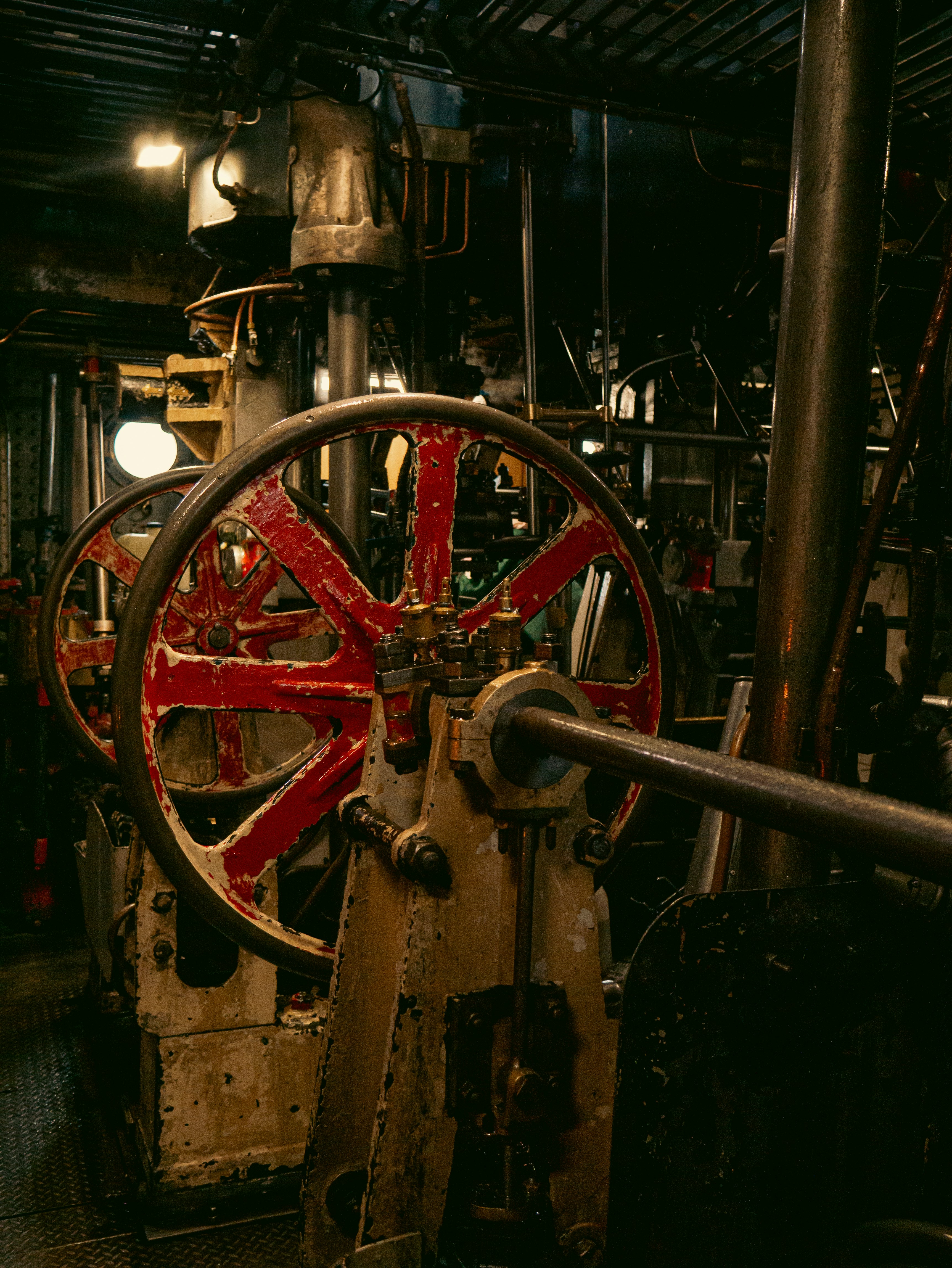 A large machine with a red wheel on it's side
