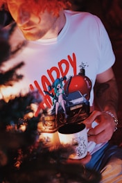 A man holding a cup with a picture on it