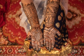 A close up of a woman's hands with hennap