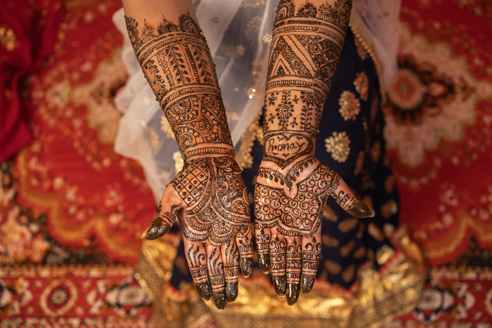 A close view of henna drying on a bride's hands.