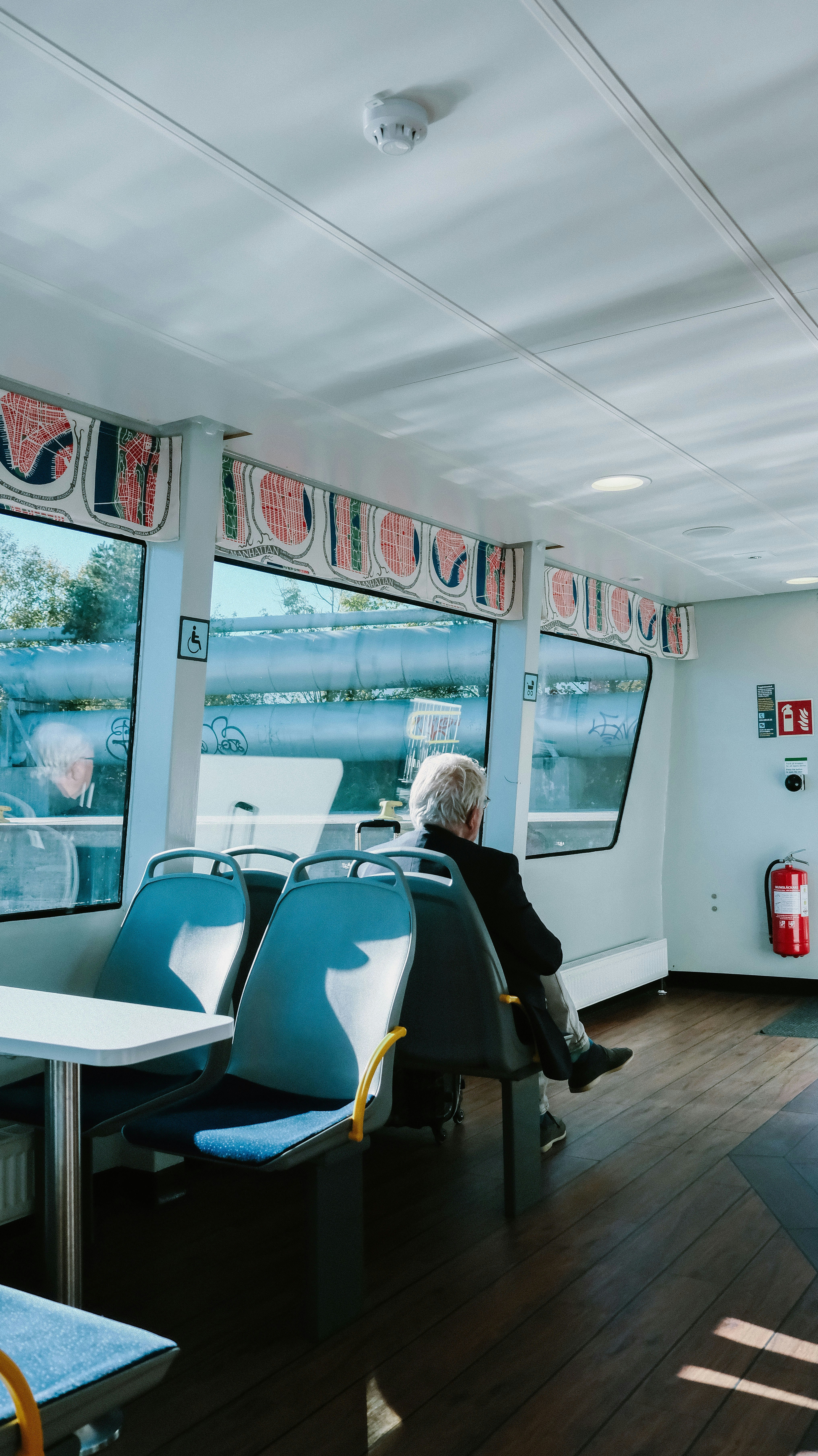 A man sitting in a train car looking out the window
