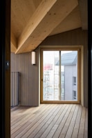 A room with a wooden floor and a glass door